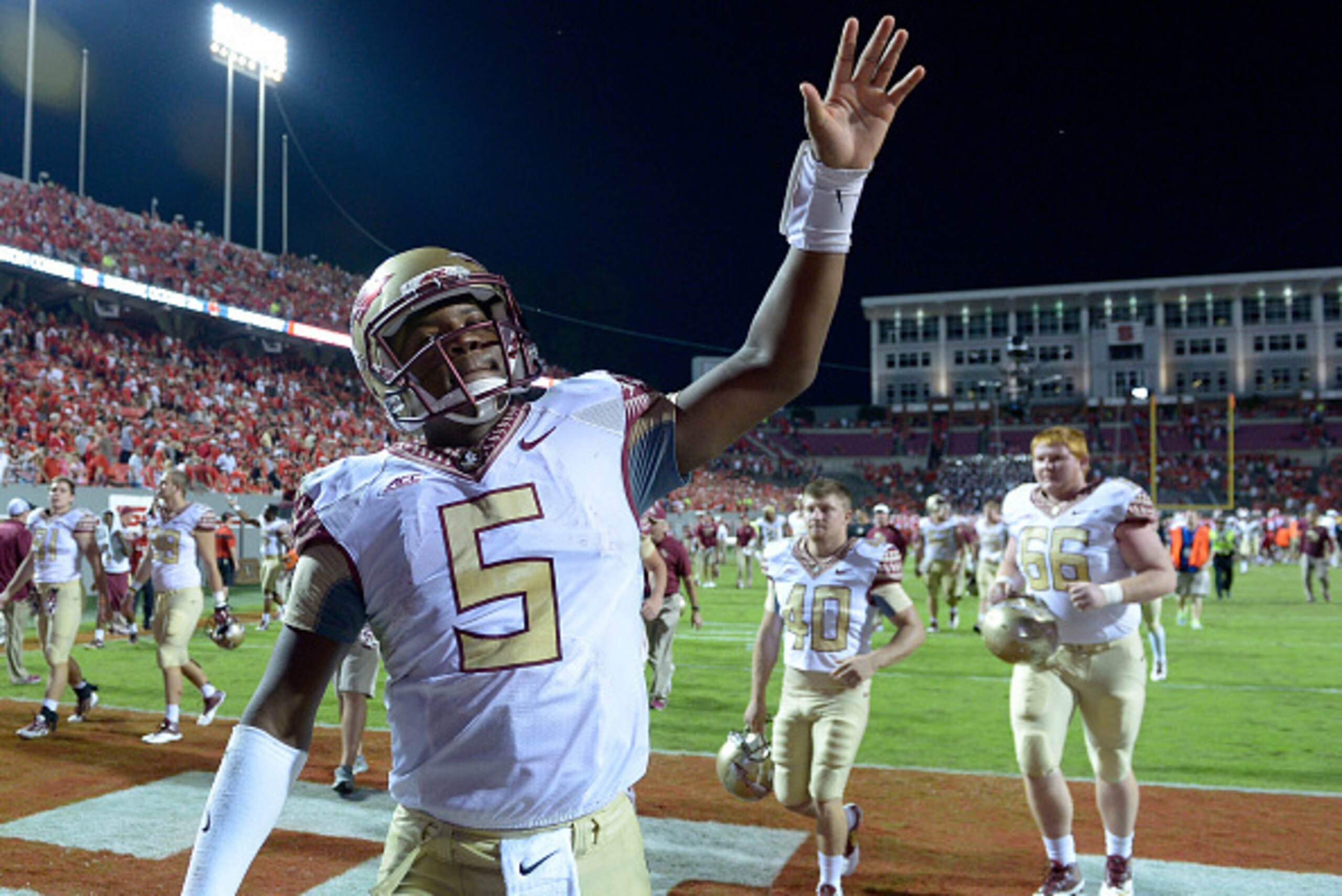 RALEIGH, NC - SEPTEMBER 27: Jameis Winston #5 of the Florida State Seminoles waves to the fans as he leaves the field after a win over the North Carolina State Wolfpack at Carter-Finley Stadium on September 27, 2014 in Raleigh, North Carolina. Florida Sta