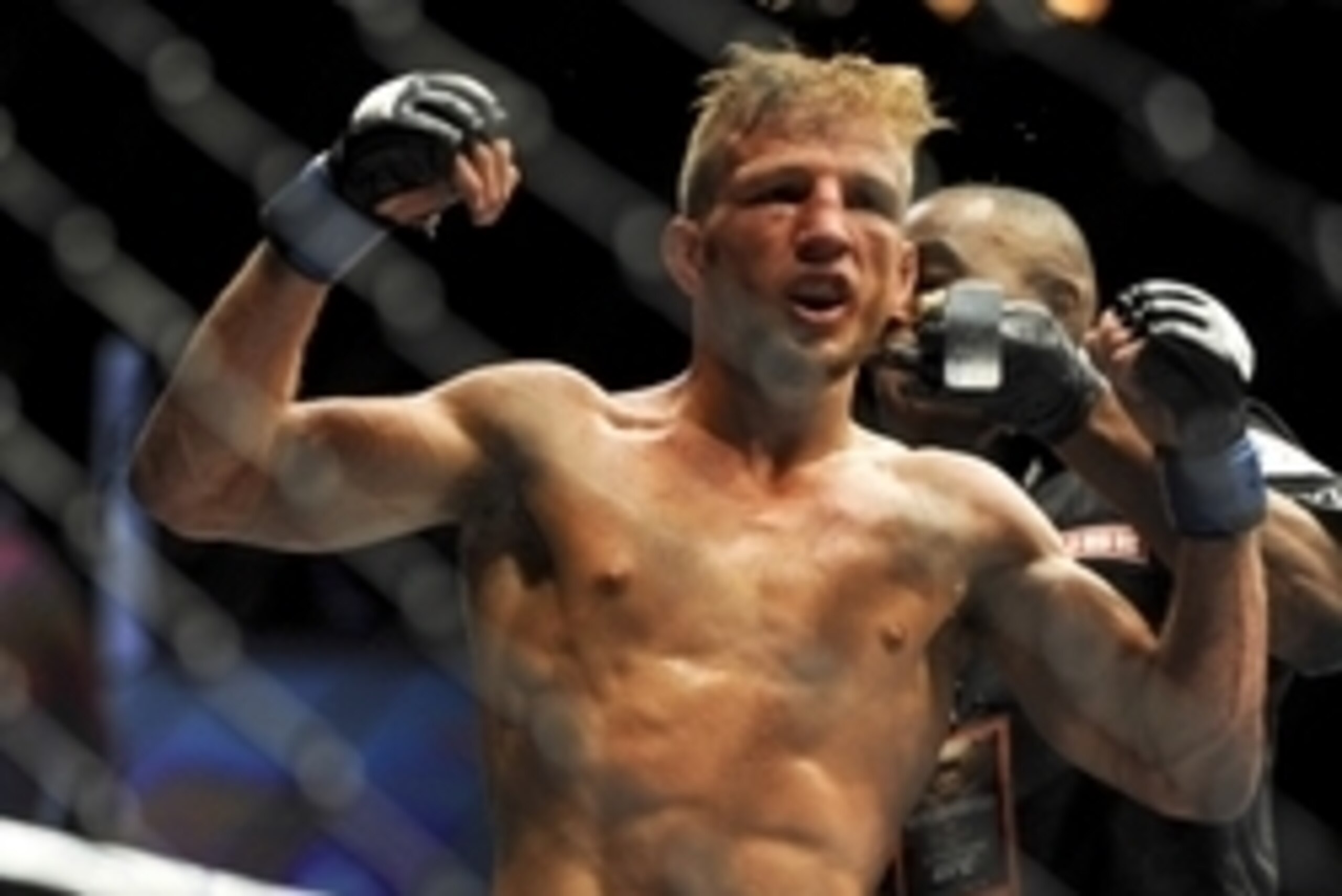 May 24, 2014; Las Vegas, NV, USA;  TJ Dillashaw (blue) celebrates after a successful third round against opponent Renan Barao (not pictured) during their UFC 173 bantamweight championship bout at MGM Grand Garden Arena. Dillashaw won the bout by way of TK