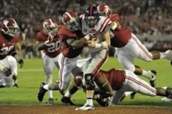 Sep 28, 2013; Tuscaloosa, AL, USA; Mississippi Rebels quarterback Bo Wallace (14) is sacked in the end zone for a safety by Alabama Crimson Tide linebacker C.J. Mosley (32) , defensive lineman Jeoffrey Pagan (8) , defensive lineman Brandon Ivory (99) duri
