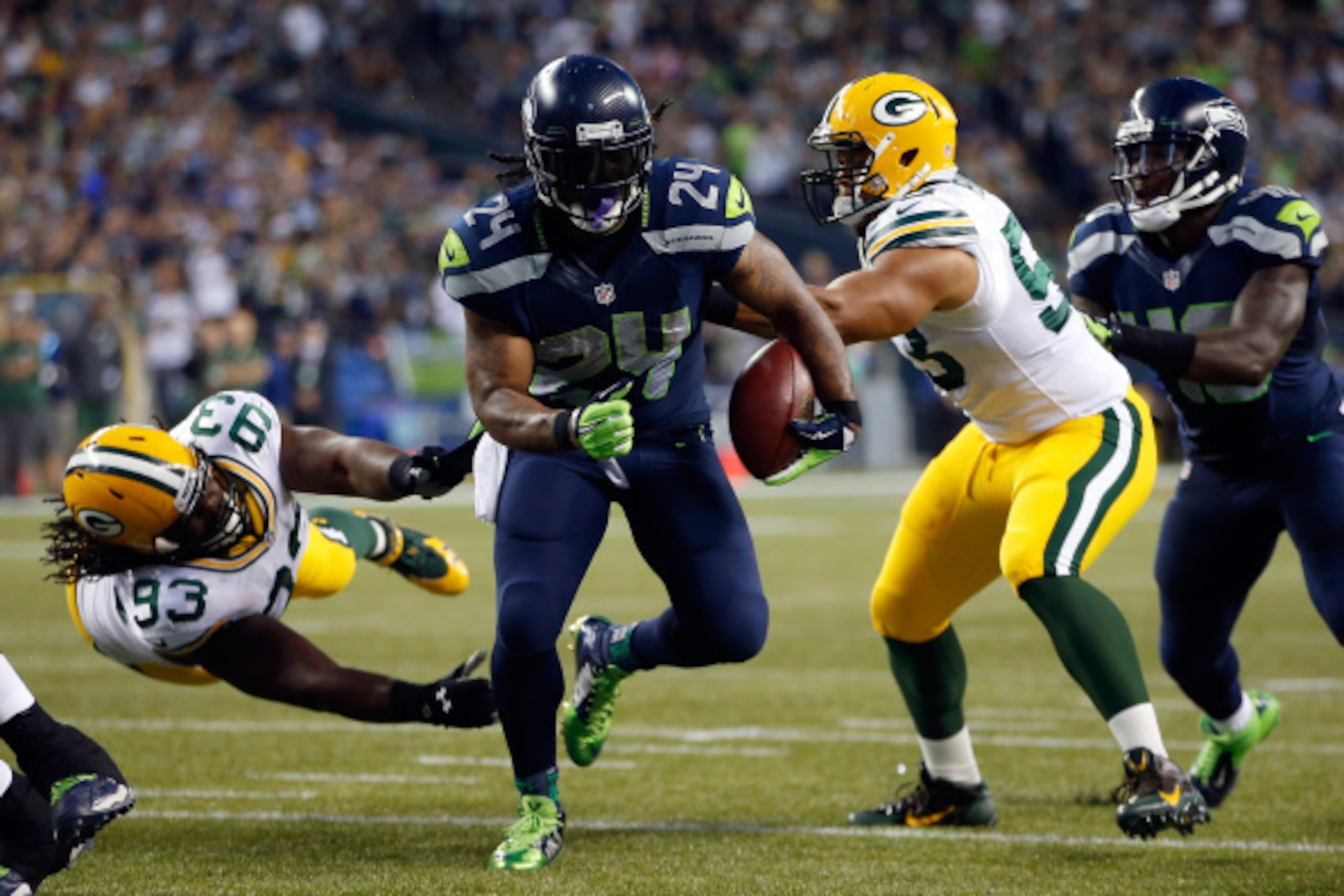 SEATTLE, WA - SEPTEMBER 04: Running back Marshawn Lynch #24 of the Seattle Seahawks breaks the tackle of linebacker Nick Perry #53 of the Green Bay Packers as he scores a touchdown during the third quarter of the game at CenturyLink Field on September 4, 