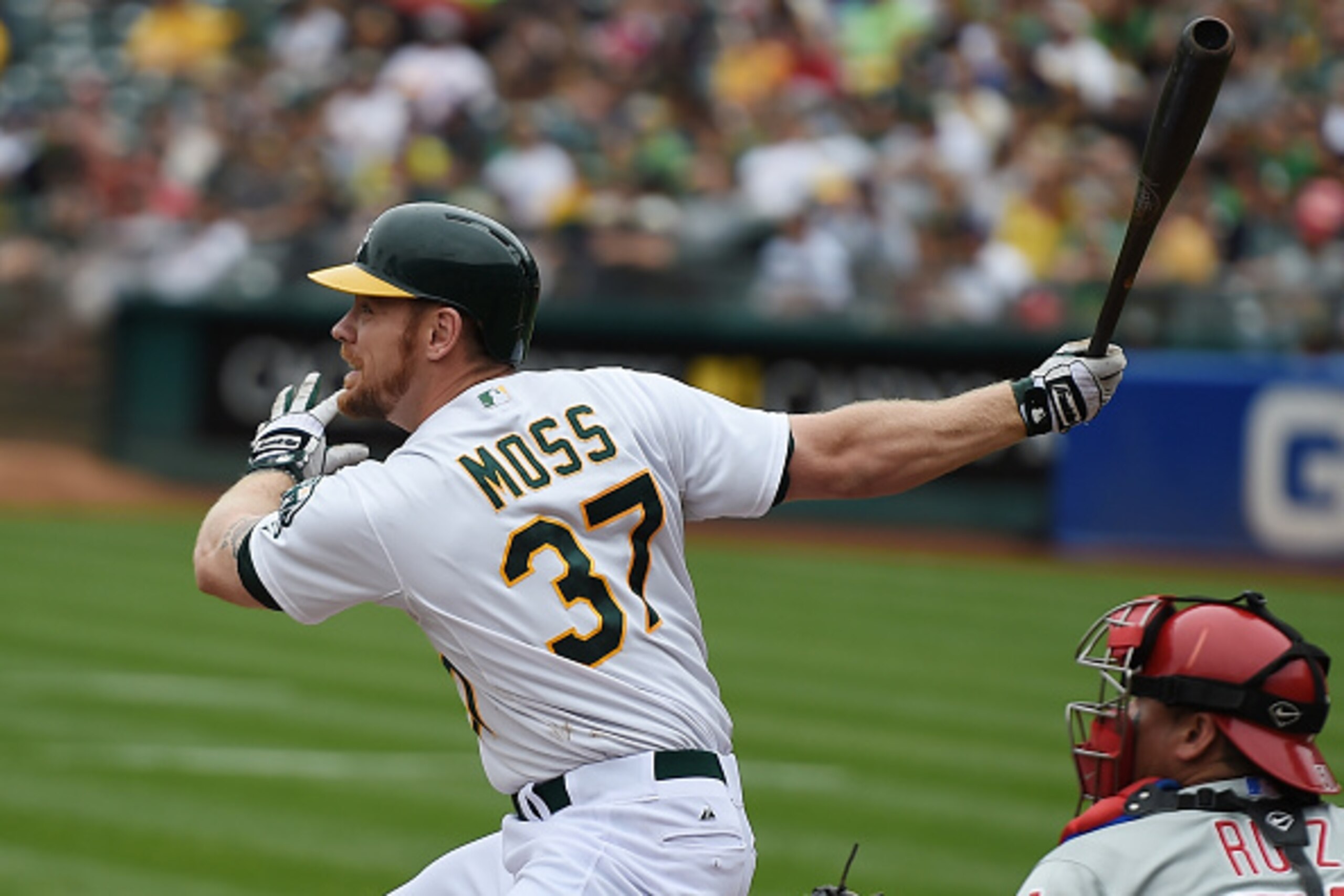 OAKLAND, CA - SEPTEMBER 21:  Brandon Moss #37 of the Oakland Athletics hits an RBI double, scoring Josh Donaldson against the Philadelphia Phillies in the bottom of the first inning at O.co Coliseum on September 21, 2014 in Oakland, California.  (Photo by
