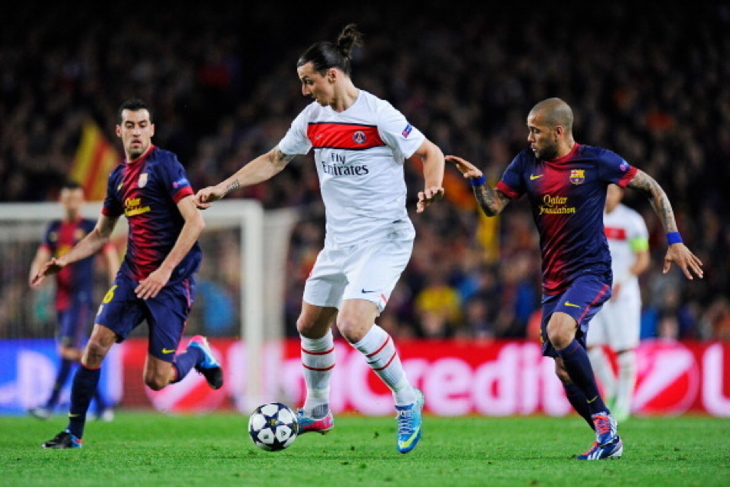 BARCELONA, SPAIN - APRIL 10:  Zlatan Ibrahimovic of PSG is marshalled by Daniel Alves of Barcelona during the UEFA Champions League quarter-final second leg match between Barcelona and Paris St Germain at Nou Camp on April 10, 2013 in Barcelona, Spain.  (