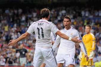 MADRID, SPAIN - SEPTEMBER 16:  Cristiano Ronaldo of Real Madrid celebrates with Gareth Bale after scoring Real's 3rd goal during the UEFA Champions League Group B match between Real Madrid CF and FC Basel 1893 on September 16, 2014 in Madrid, Spain.  (Pho