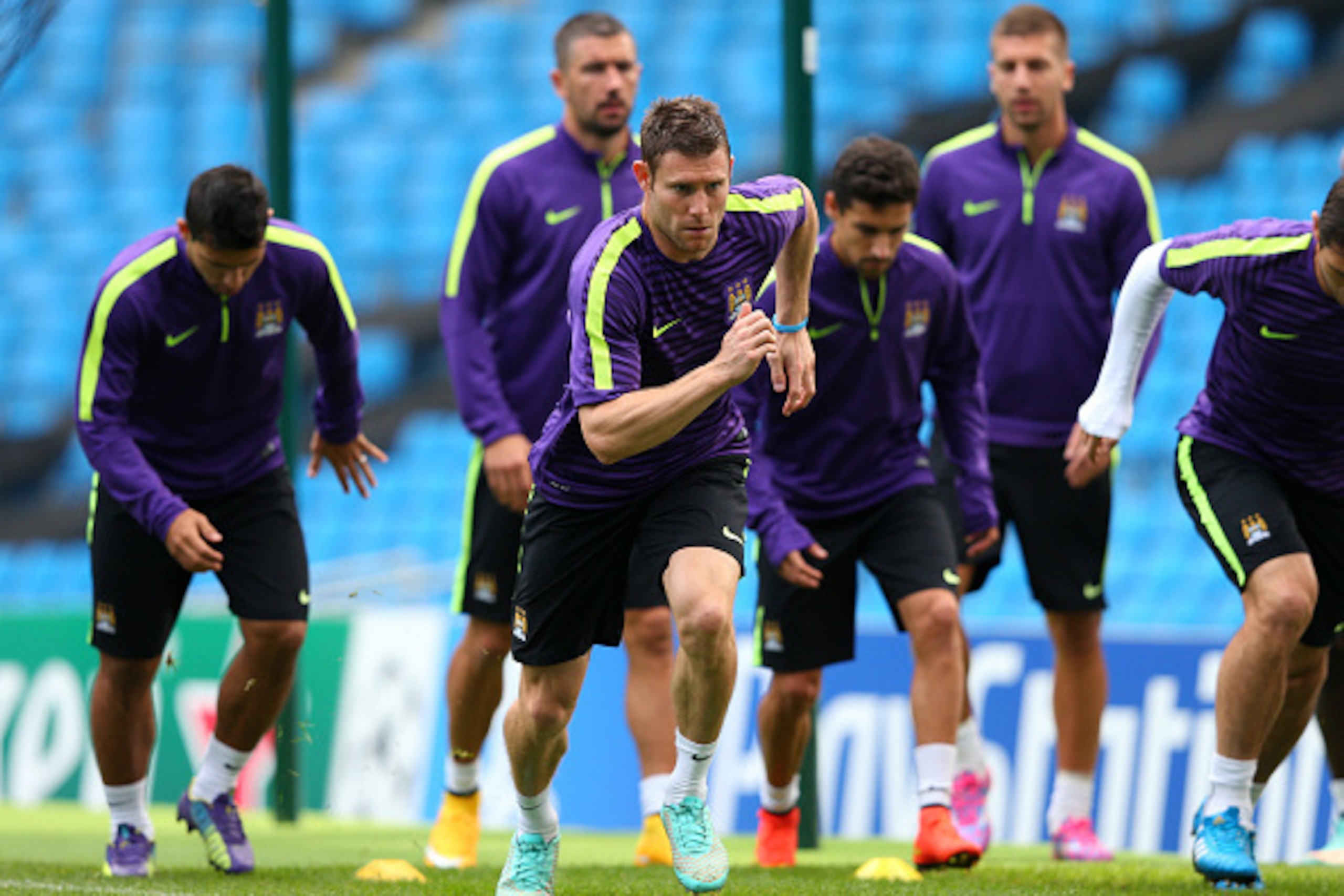 MANCHESTER, ENGLAND - SEPTEMBER 29:  James Milner of Manchester City runs through a training drill during a training session at the Etihad Stadium on September 29, 2014 in Manchester, England.  (Photo by Alex Livesey/Getty Images)