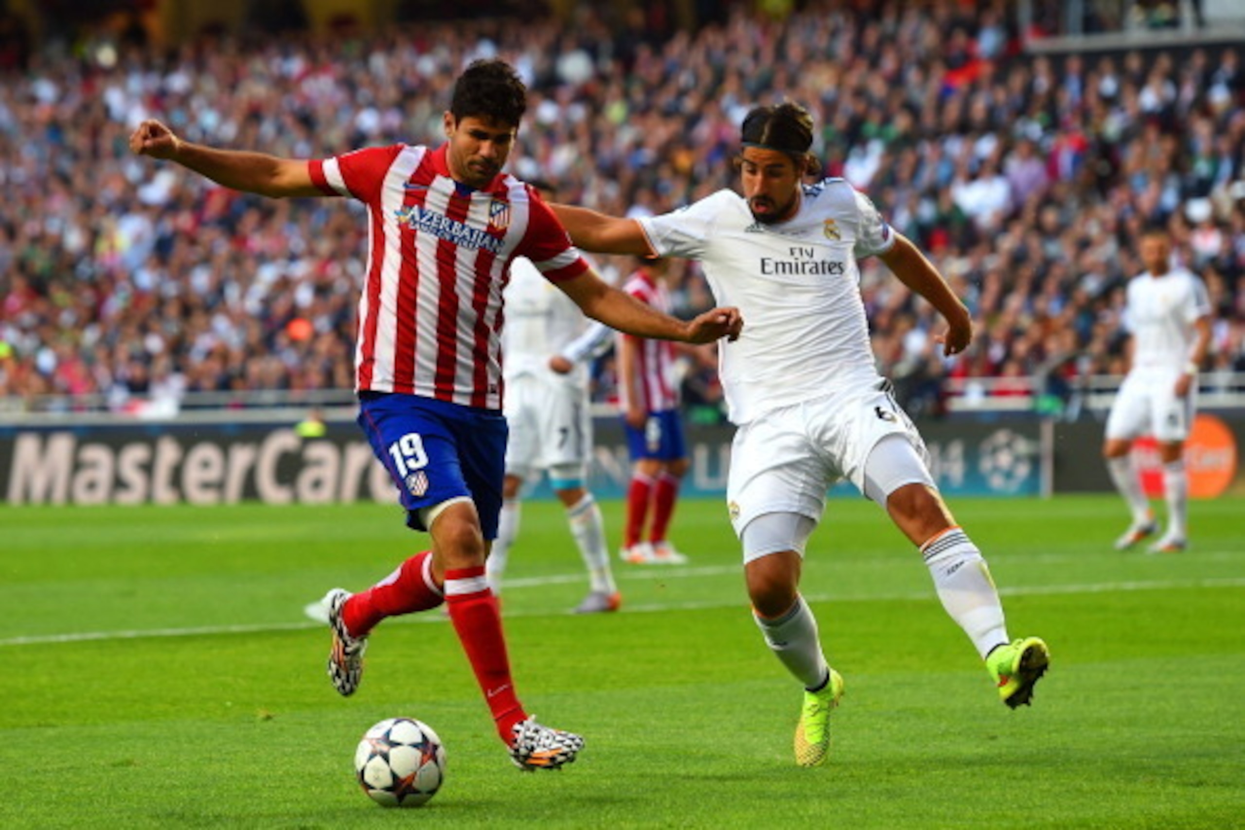 LISBON, PORTUGAL - MAY 24:  Diego Costa of Club Atletico de Madrid is marshalled by Sami Khedira of Real Madrid during the UEFA Champions League Final between Real Madrid and Atletico de Madrid at Estadio da Luz on May 24, 2014 in Lisbon, Portugal.  (Phot
