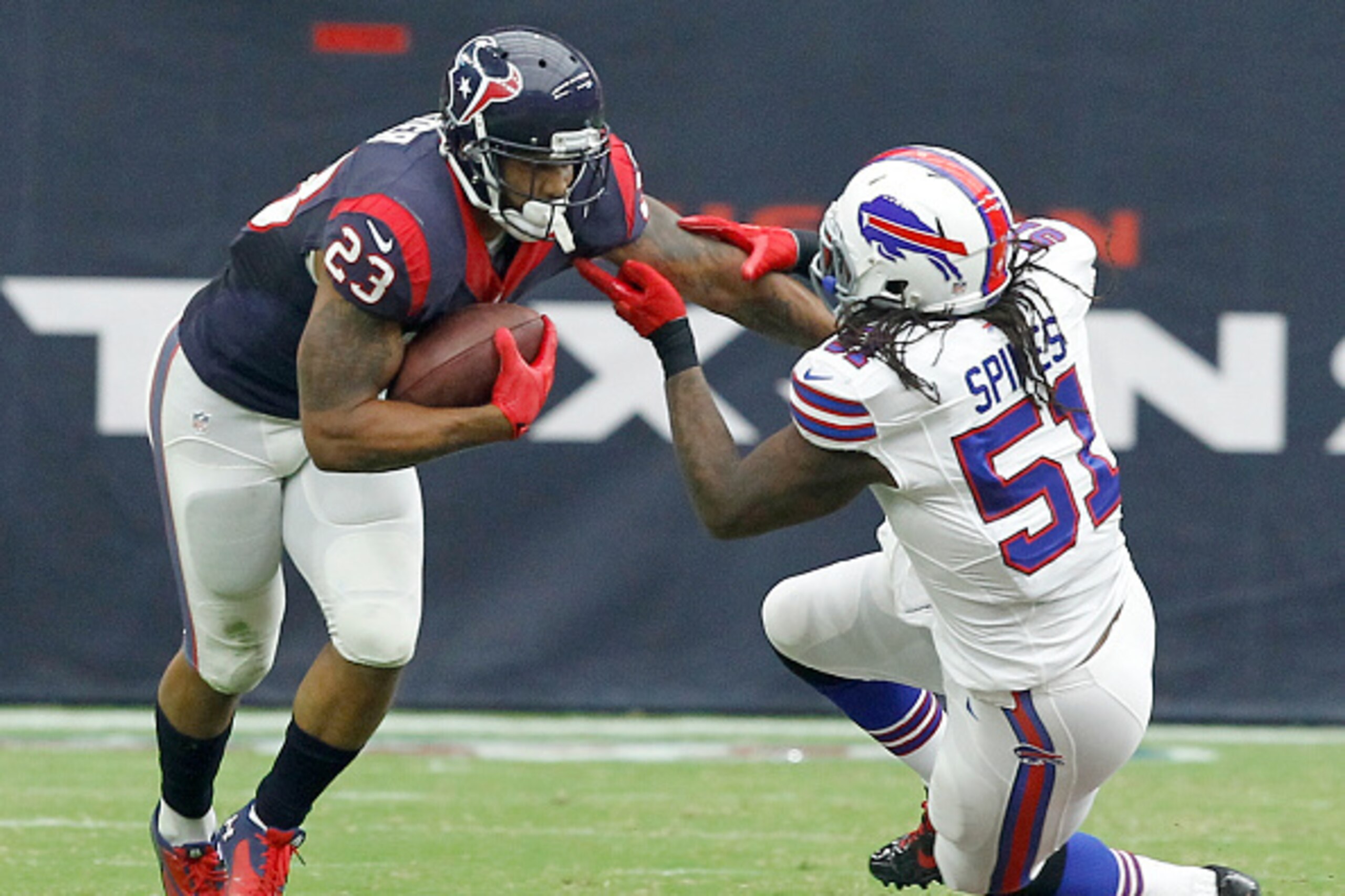HOUSTON, TX- SEPTEMBER 28: Arian Foster #23 of the Houston Texans breaks the tackle of Brandon Spikes #51 of the Buffalo Bills in a NFL game on September 28, 2014 at NRG Stadium in Houston, Texas. (Photo by Bob Levey/Getty Images)