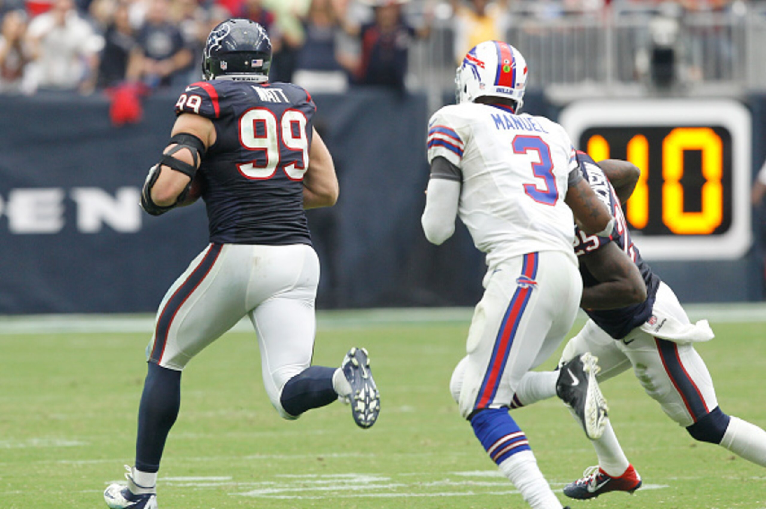 HOUSTON, TX- SEPTEMBER 28: J.J. Watt #99 of the Houston Texans intercepts EJ Manuel #3 of the Buffalo Bills pass and returned it for a 80 yard touchdown in the third quarter in a NFL game on September 28, 2014 at NRG Stadium in Houston, Texas. (Photo by B