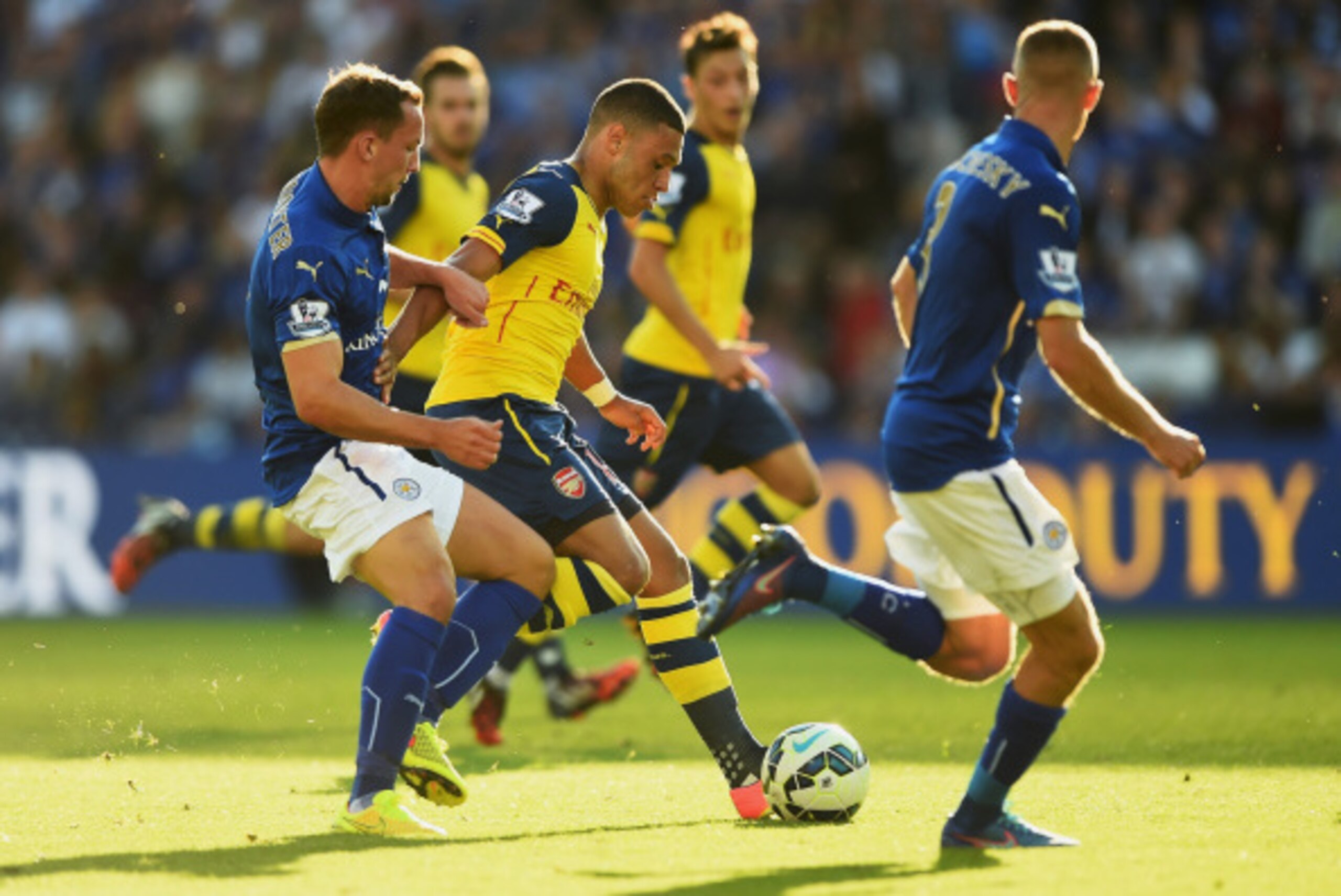 LEICESTER, ENGLAND - AUGUST 31:  Alex Oxlade-Chamberlain of Arsenal is tackled by Daniel Drinkwater of Leicester City during the Barclays Premier League match between Leicester City and Arsenal at The King Power Stadium on August 31, 2014 in Leicester, En