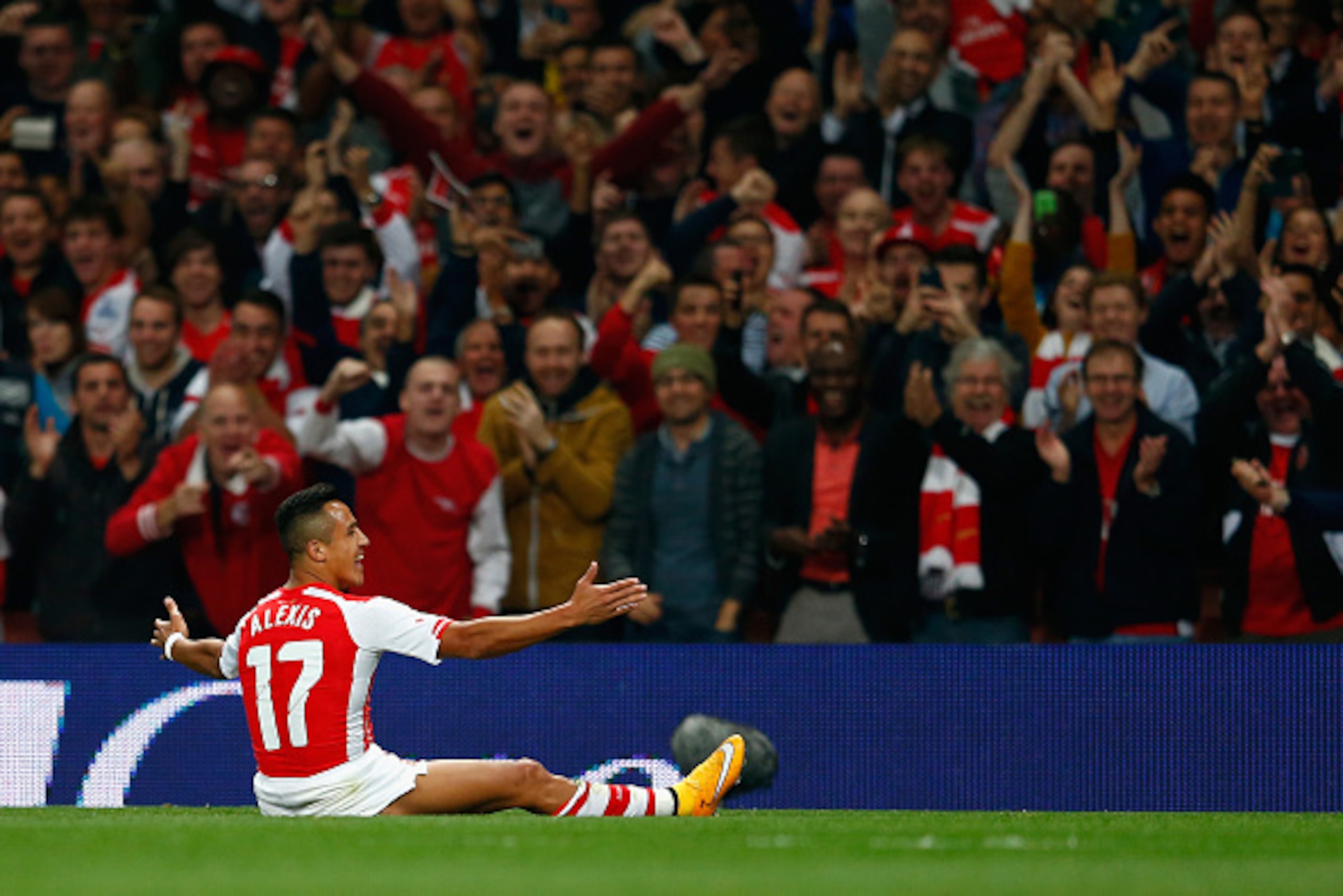 LONDON, ENGLAND - SEPTEMBER 23:  Alexis Sanchez of Arsenal celebrates scoring a free kick to make it 1-0 during the Capital One Cup Third Round match between Arsenal and Southampton at the Emirates Stadium on September 23, 2014 in London, England.  (Photo