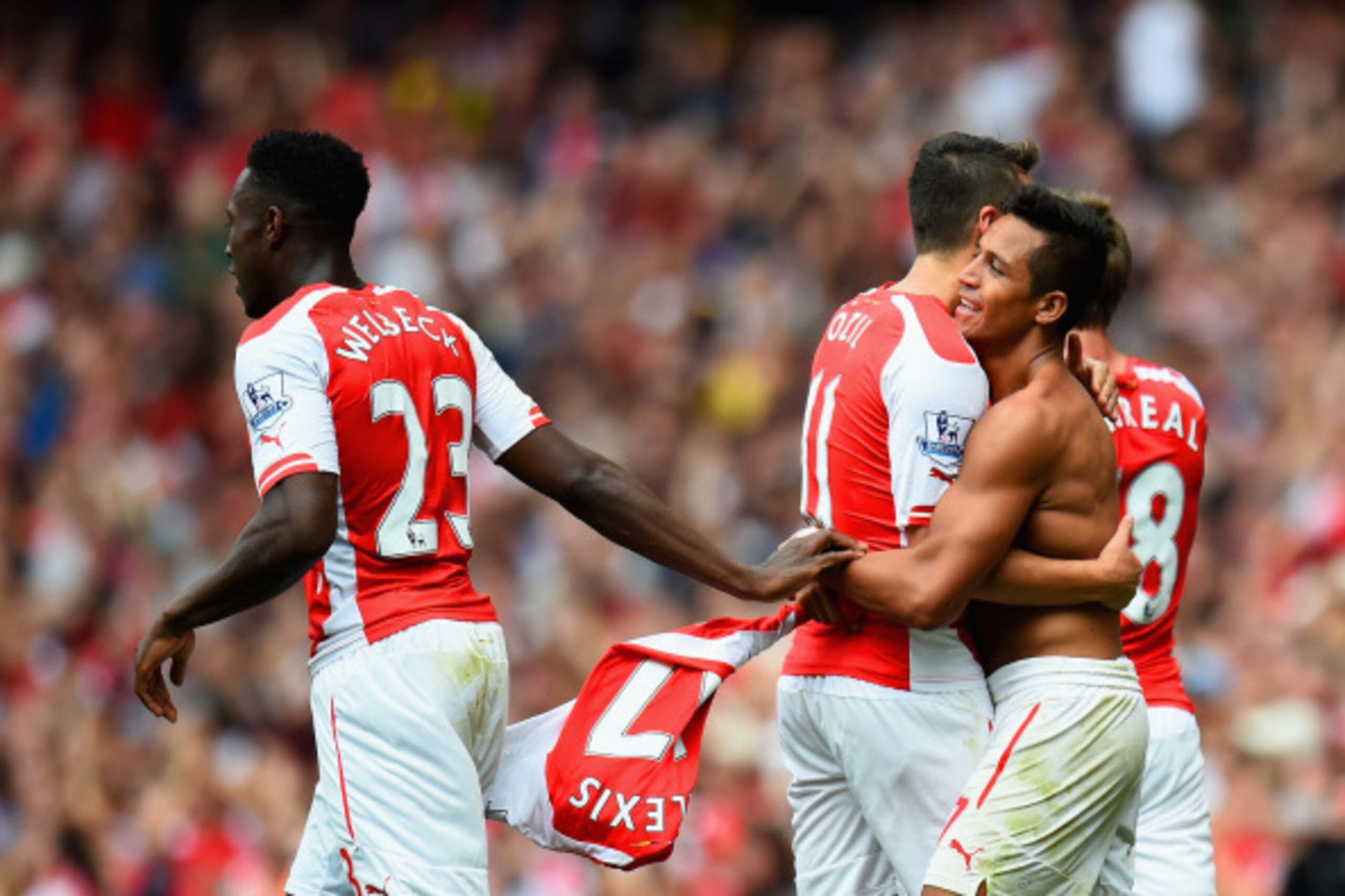 LONDON, ENGLAND - SEPTEMBER 13:  Alexis Sanchez of Arsenal celebrates scoring their second goal with Mesut Oezil  and Danny Welbeck of Arsenal  during the Barclays Premier League match between Arsenal and Manchester City at Emirates Stadium on September 1