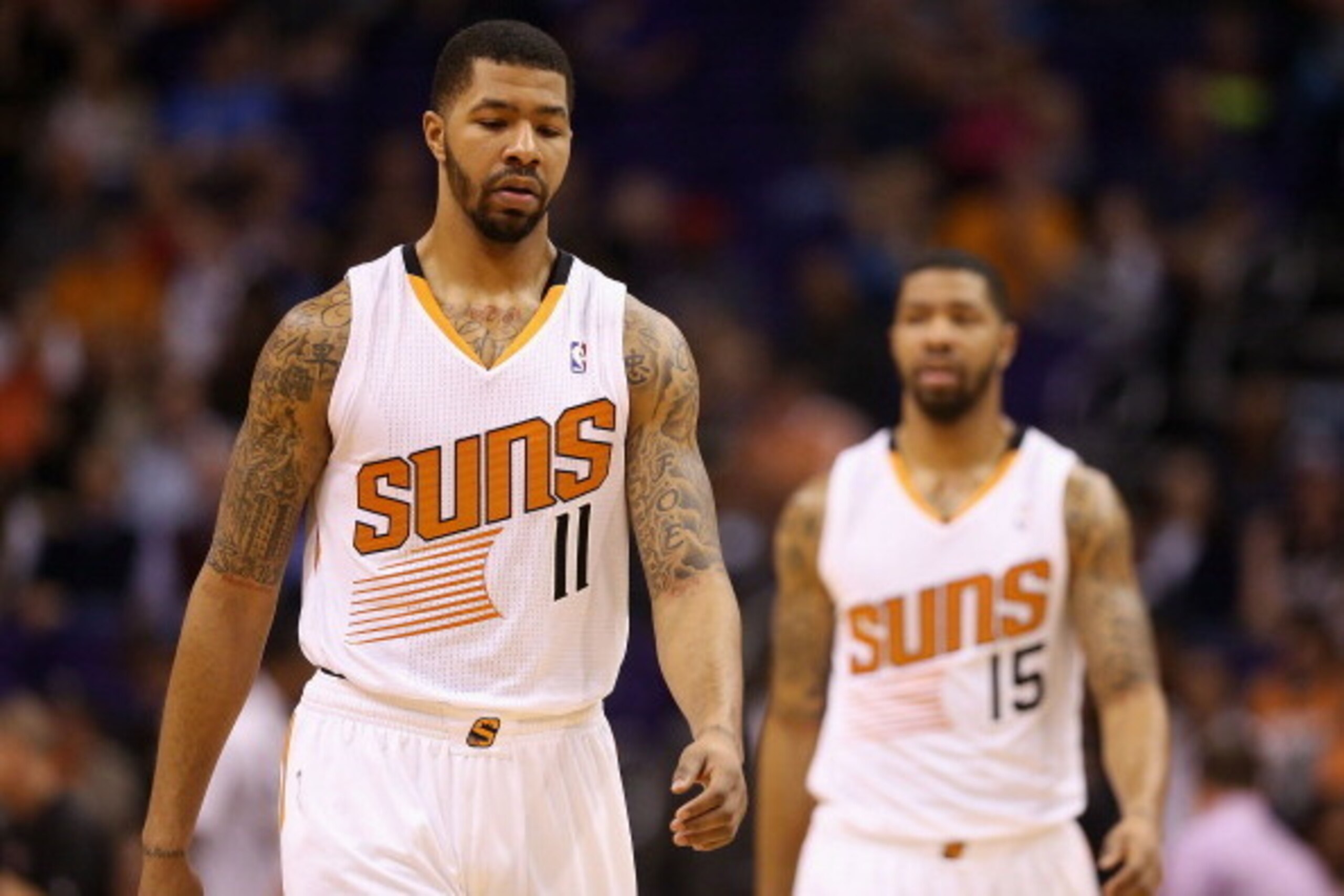 PHOENIX, AZ - FEBRUARY 11:  (L-R) Markieff Morris #11 and Marcus Morris #15 of the Phoenix Suns during the NBA game against the Miami Heat at US Airways Center on February 11, 2014 in Phoenix, Arizona. The Heat defeated the Suns 103-97.  NOTE TO USER: Use