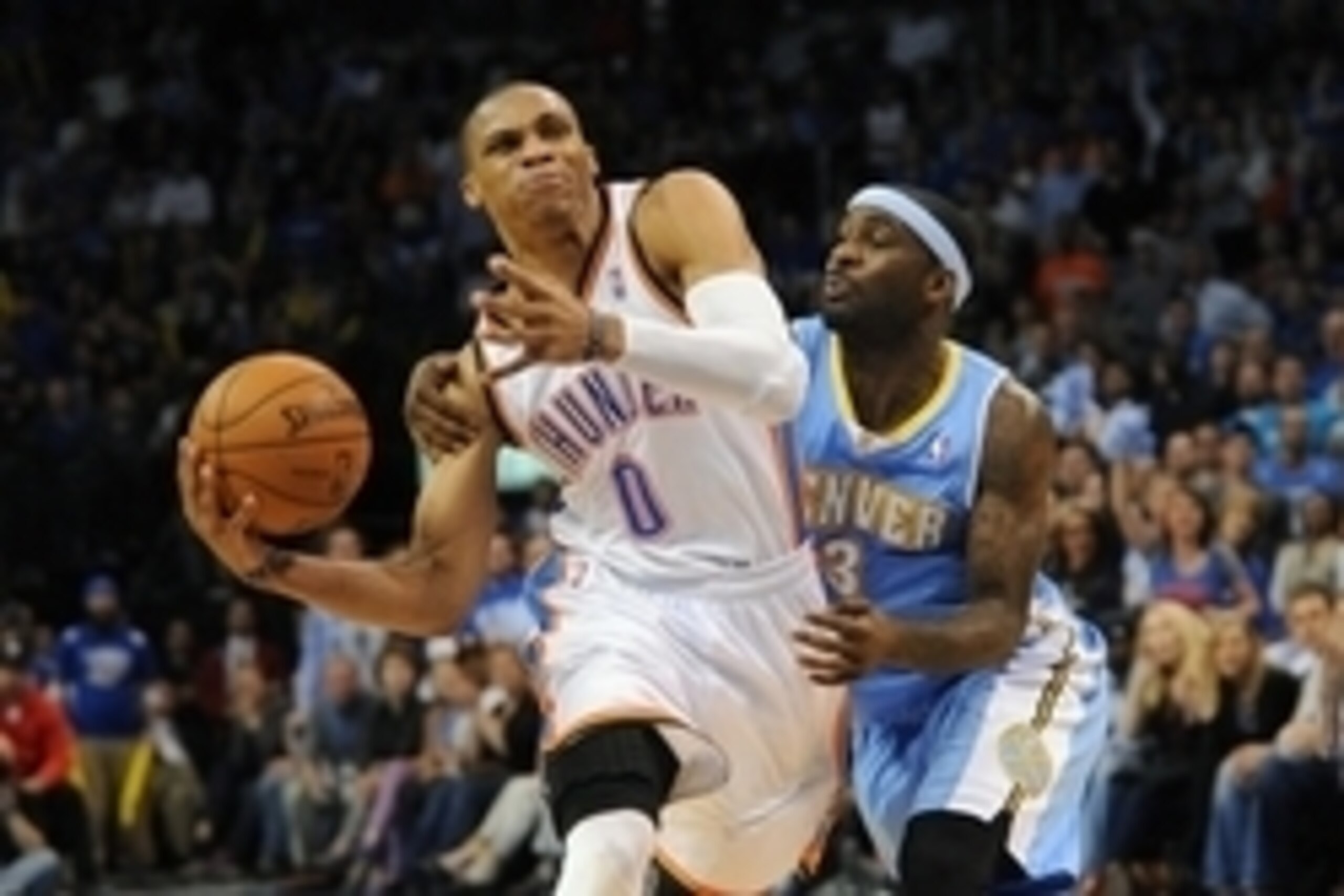 Mar 19, 2013; Oklahoma City, OK, USA; Oklahoma City Thunder guard Russell Westbrook (0) handles the ball against Denver Nuggets guard Ty Lawson (3) during the second half at Chesapeake Energy Arena. Mandatory Credit: Mark D. Smith-USA TODAY Sports