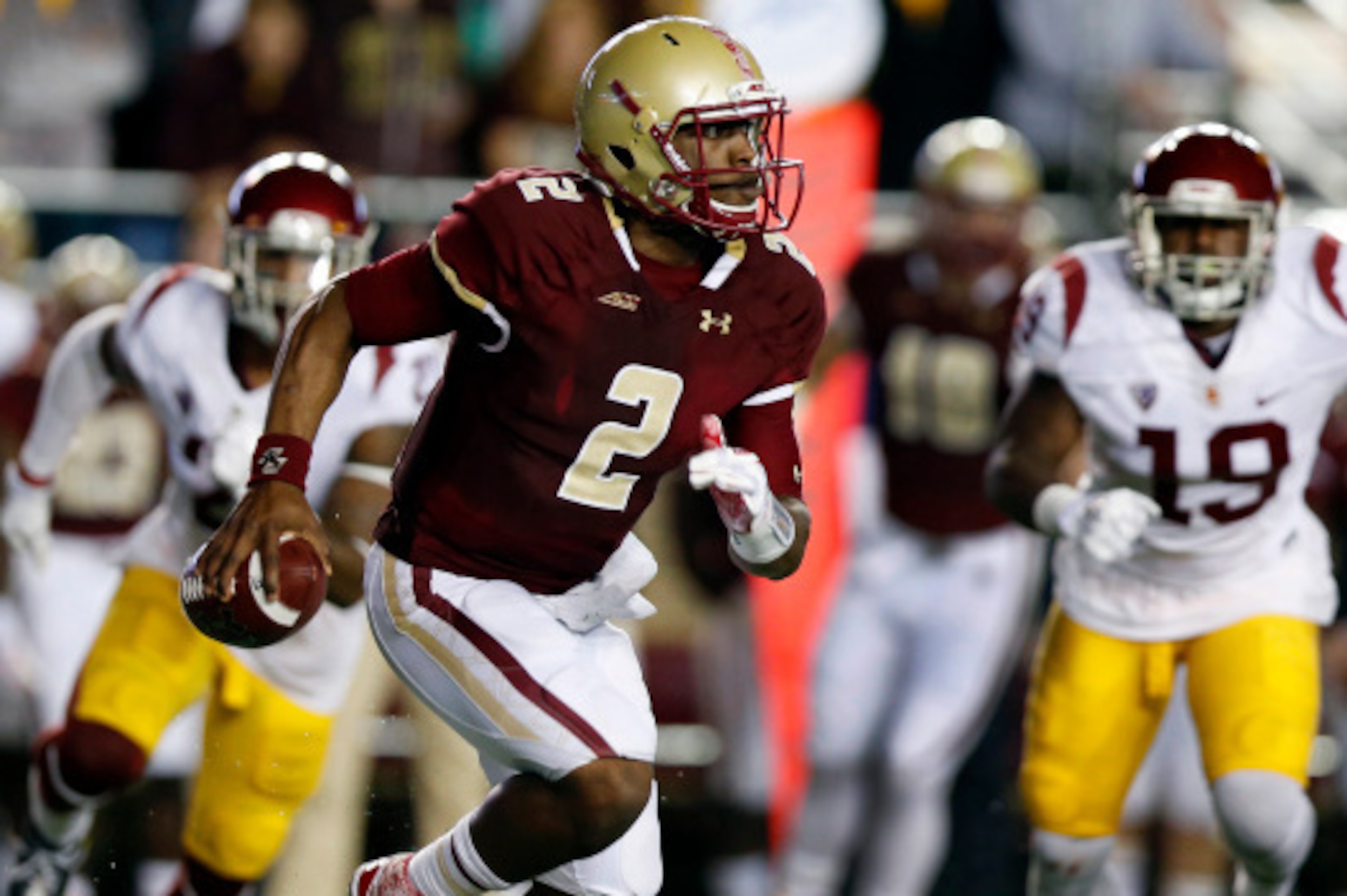 BOSTON, MA- SEPTEMBER 13: Quarterback Tyler Murphy #2 of the Boston College Eagle scrambles away from linebacker Michael Hutchings #19 of the USC Trojans during the first half at Alumni Stadium on September 13 in Chestnut Hill, Massachusetts.  (Photo by W
