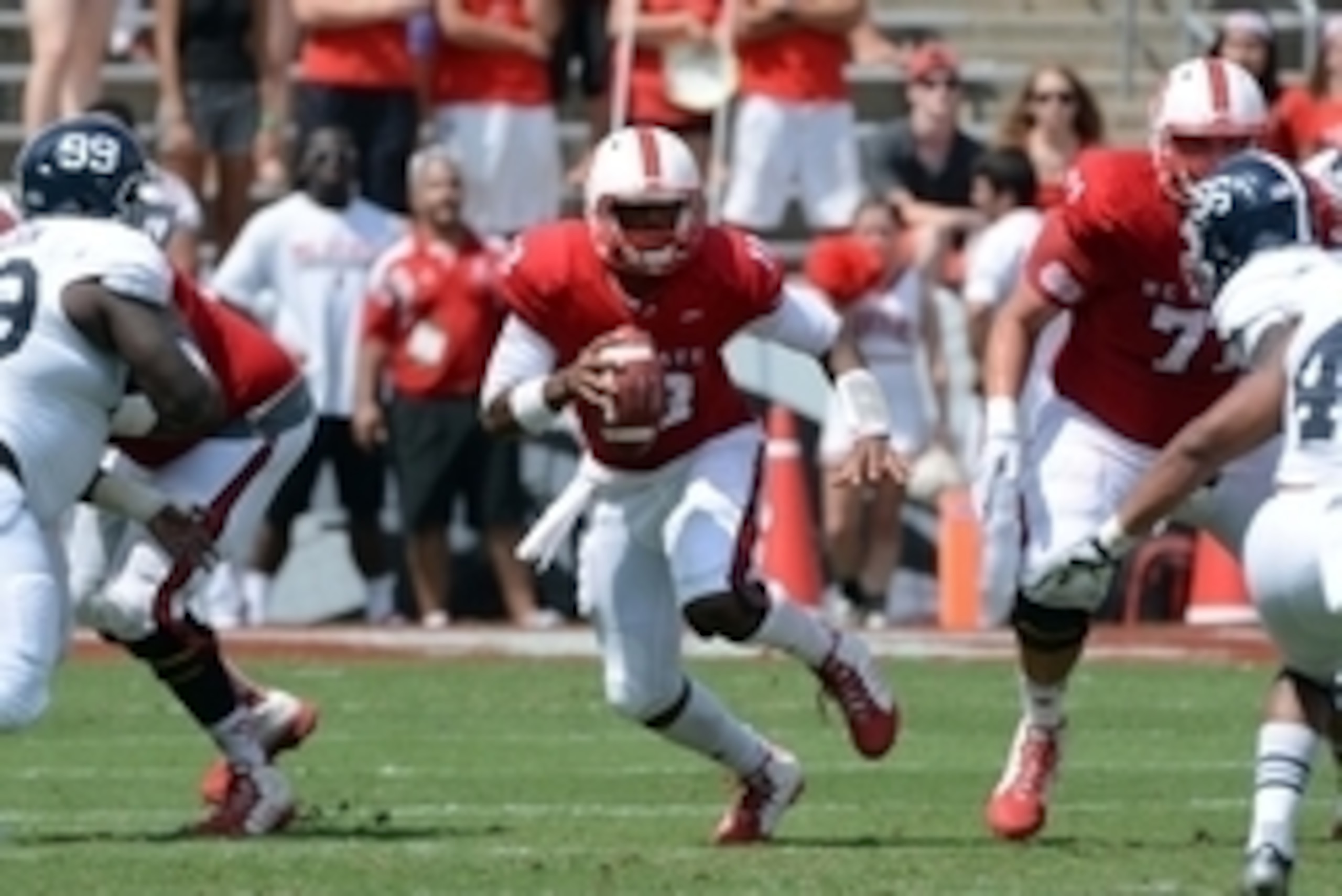 Aug 30, 2014; Raleigh, NC: North Carolina State Wolfpack quarterback Jacoby Brissett (12) scrambles during the second half against Georgia Southern at Carter Finley Stadium. North Carolina State won 24-23. Mandatory Credit: Rob Kinnan-USA Today