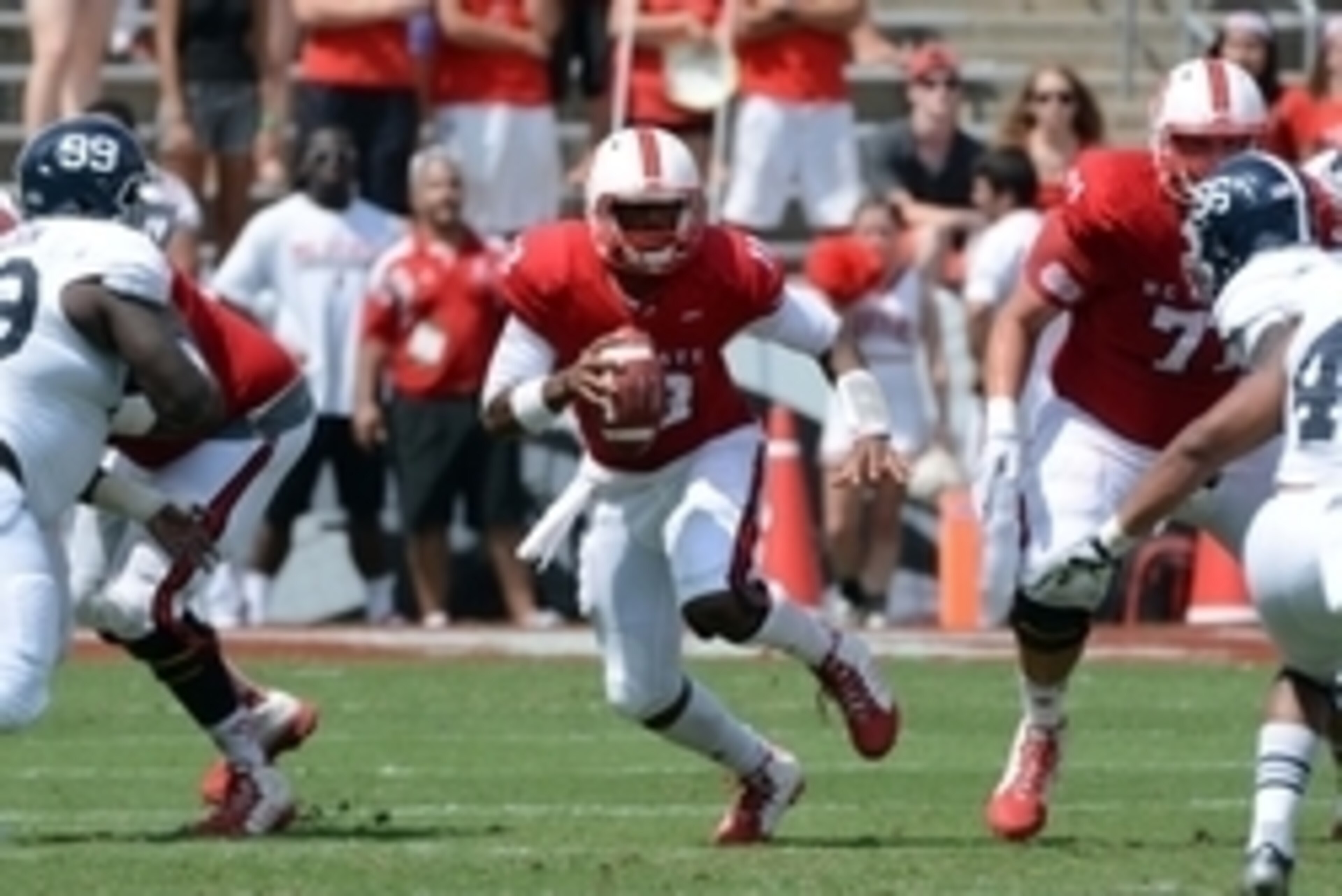 Aug 30, 2014; Raleigh, NC: North Carolina State Wolfpack quarterback Jacoby Brissett (12) scrambles during the second half against Georgia Southern at Carter Finley Stadium. North Carolina State won 24-23. Mandatory Credit: Rob Kinnan-USA Today