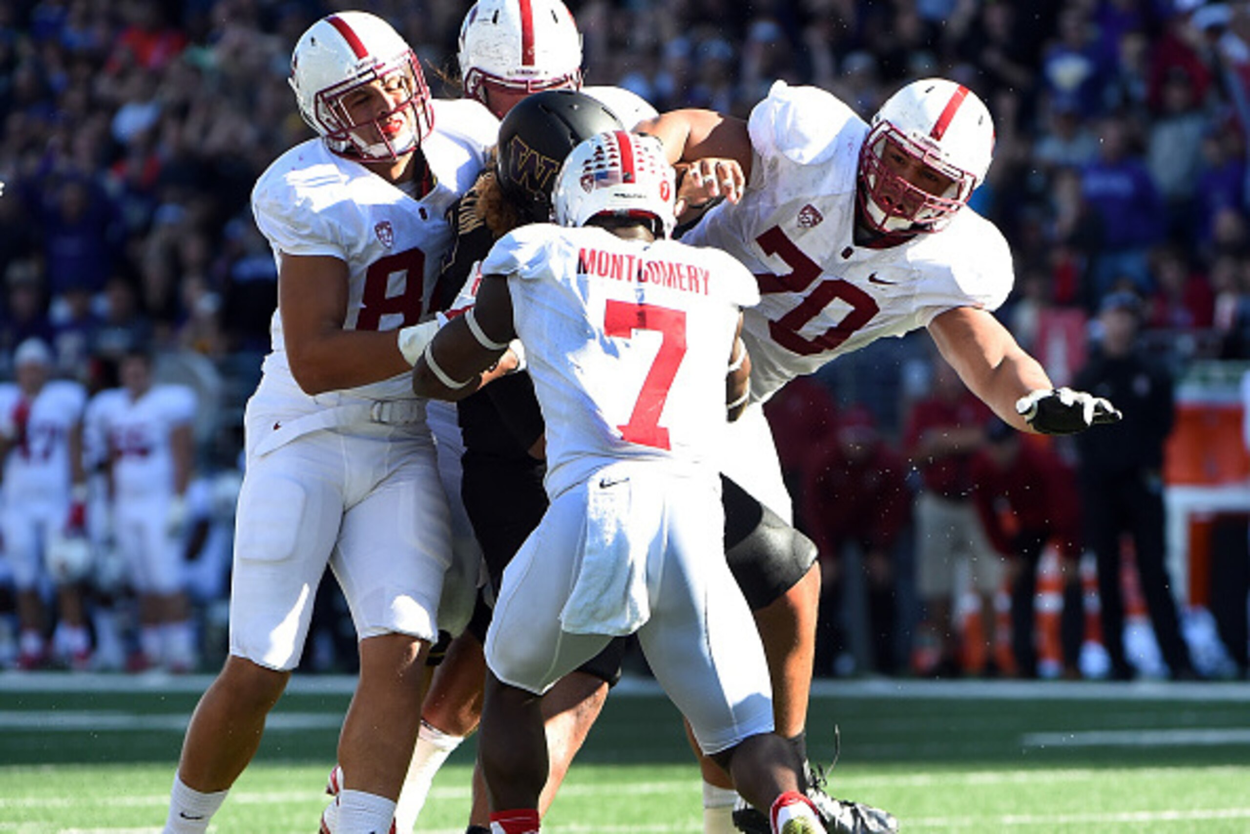 SEATTLE, WA - SEPTEMBER 27: Defensive lineman Danny Shelton #55 of the Washington Huskies is tackled by wide receiver Ty Montgomery #7 of the Stanford Cardinal and other Cardinal players after he recovered a fumble during the fourth quarter of the game at