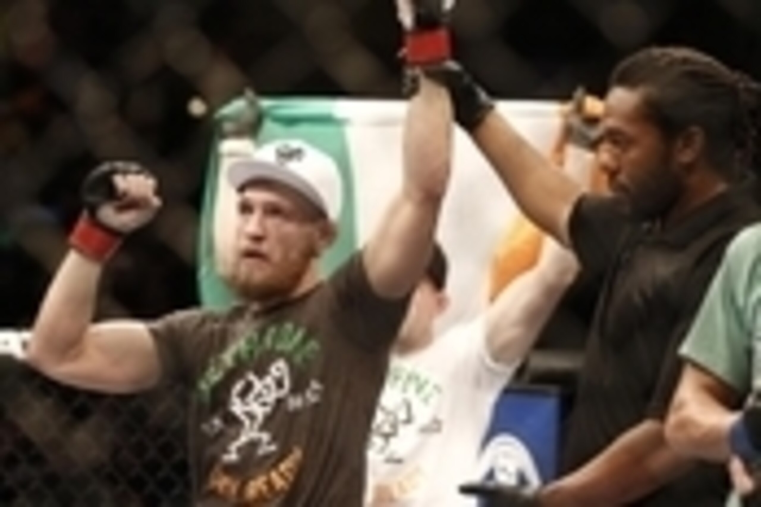 Aug 17, 2013; Boston, MA, USA; Conor McGregor (left) celebrates his win over Max Holloway (right) after a UFC featherweight match at the TD Garden. McGregor won after three rounds by judges decision. Mandatory Credit: Winslow Townson-USA TODAY Sports