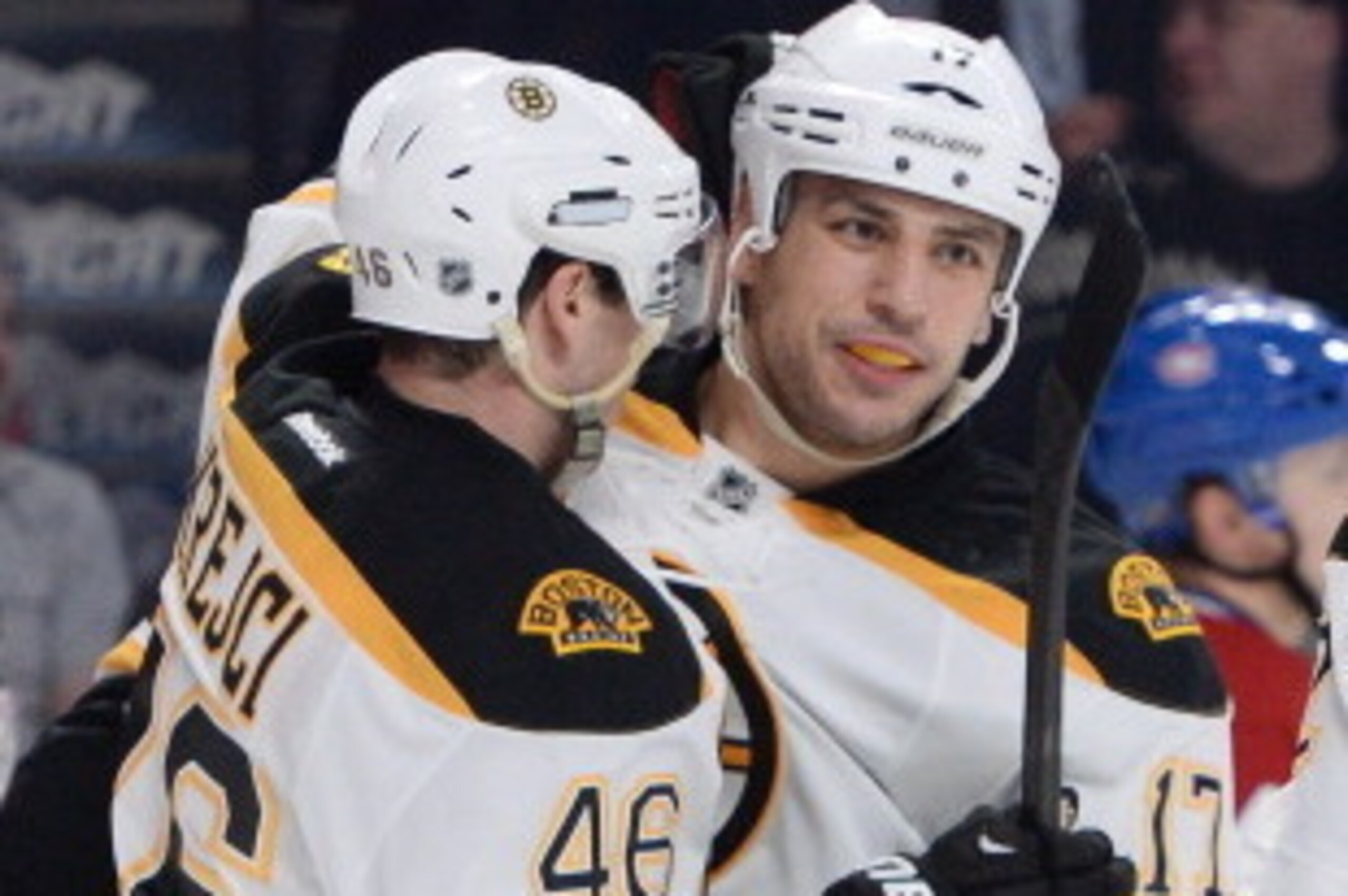 MONTREAL, QC - MARCH 12: Milan Lucic #17 of the Boston Bruins celebrates after scoring a goal against the Montreal Canadiens with teammates David Krejci #46 and Jarome Iginla #12 during the NHL game on March 12, 2014 at the Bell Centre in Montreal, Quebec