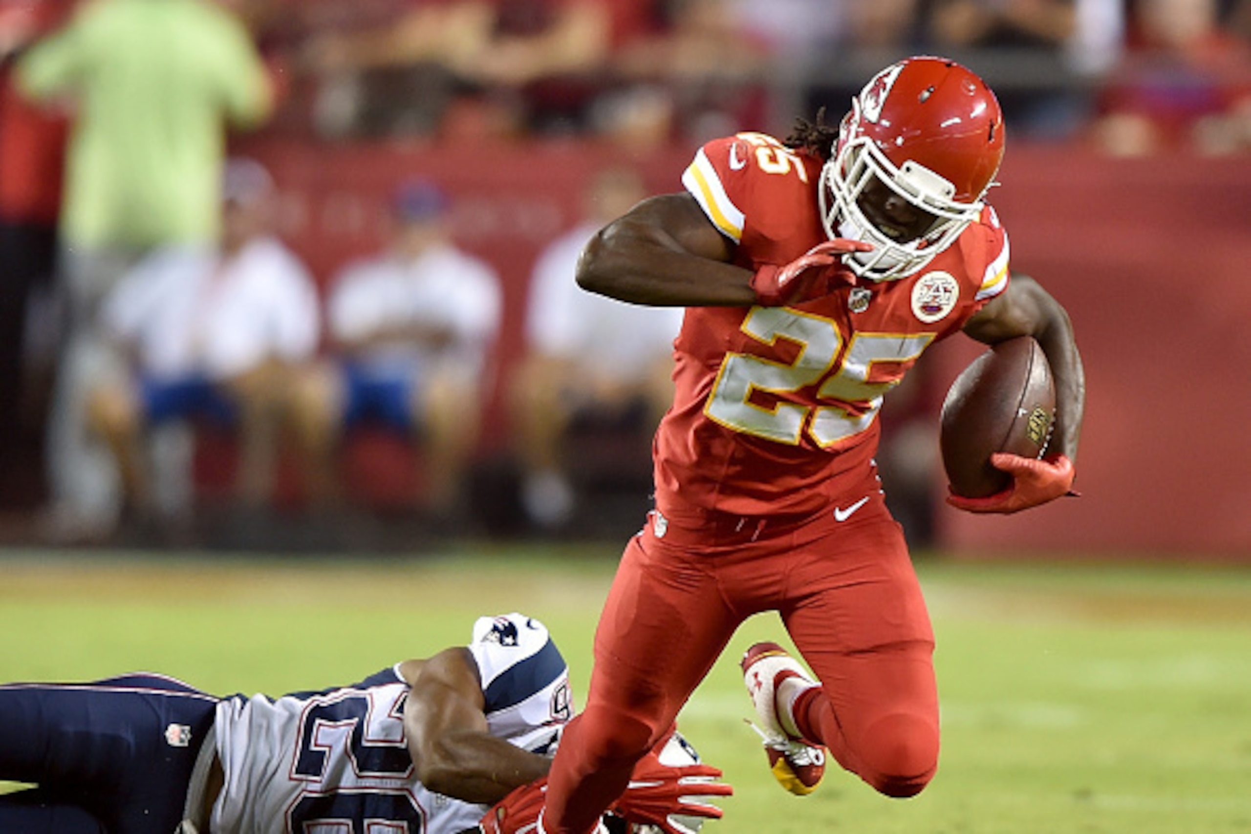 KANSAS CITY, MO - SEPTEMBER 29: Jamaal Charles #25 of the Kansas City Chiefs is tripped up by Logan Ryan #26 of the New England Patriots during the first quarter at Arrowhead Stadium on September 29, 2014 in Kansas City, Missouri. (Photo by Peter Aiken/G KANSAS CITY, MO - SEPTEMBER 29: Jamaal Charles #25 of the Kansas City Chiefs is tripped up by Logan Ryan #26 of the New England Patriots during the first quarter at Arrowhead Stadium on September 29, 2014 in Kansas City, Missouri. (Photo by Peter Aiken/G