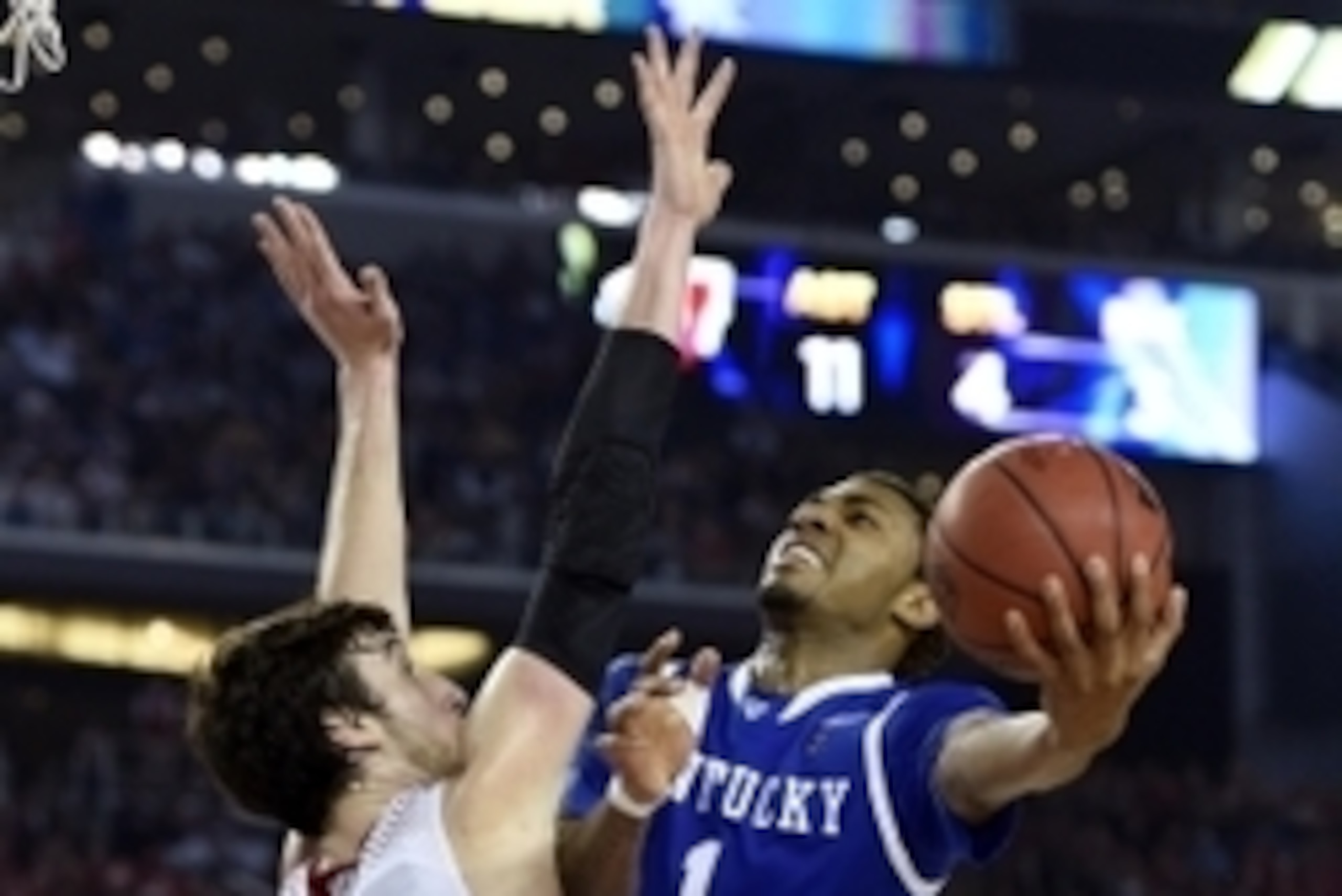 Apr 5, 2014; Arlington, TX, USA; Kentucky Wildcats guard/forward James Young (1) shoots against Wisconsin Badgers forward Frank Kaminsky (44) during the semifinals of the Final Four in the 2014 NCAA Mens Division I Championship tournament at AT&T Stadium.