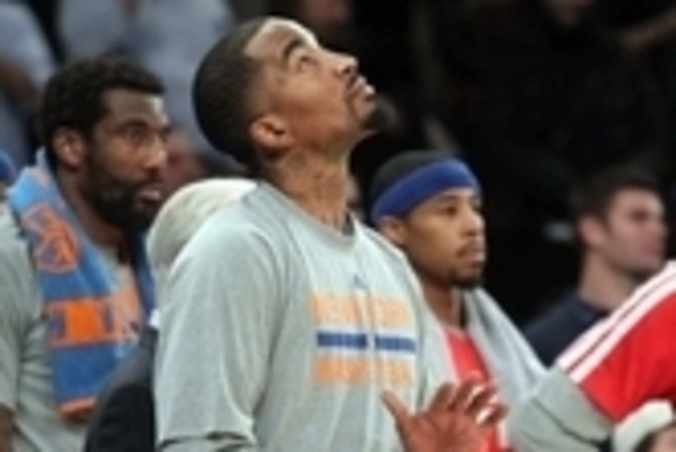 Jan 9, 2014; New York, NY, USA; New York Knicks shooting guard J.R. Smith (8) watches the final seconds of the game from the bench during the fourth quarter of a game against the Miami Heat at Madison Square Garden. Smith didn't play in the game. Mandator