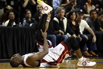 MIAMI - APRIL 23:  Guard Dwyane Wade #3 of the Miami Heat stays on the floor injured during a 100-98 loss to the Boston Celtics in Game Three of the Eastern Conference Quarterfinals during the 2010 NBA Playoffs at American Airlines Arena on April 23, 2010