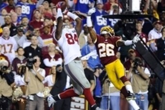 Sep 25, 2014; Landover, MD, USA; New York Giants tight end Larry Donnell (84) catches a touchdown pass as Washington Redskins strong safety Bashaud Breeland (26) defends during the first half at FedEx Field. Mandatory Credit: Brad Mills-USA TODAY Sports