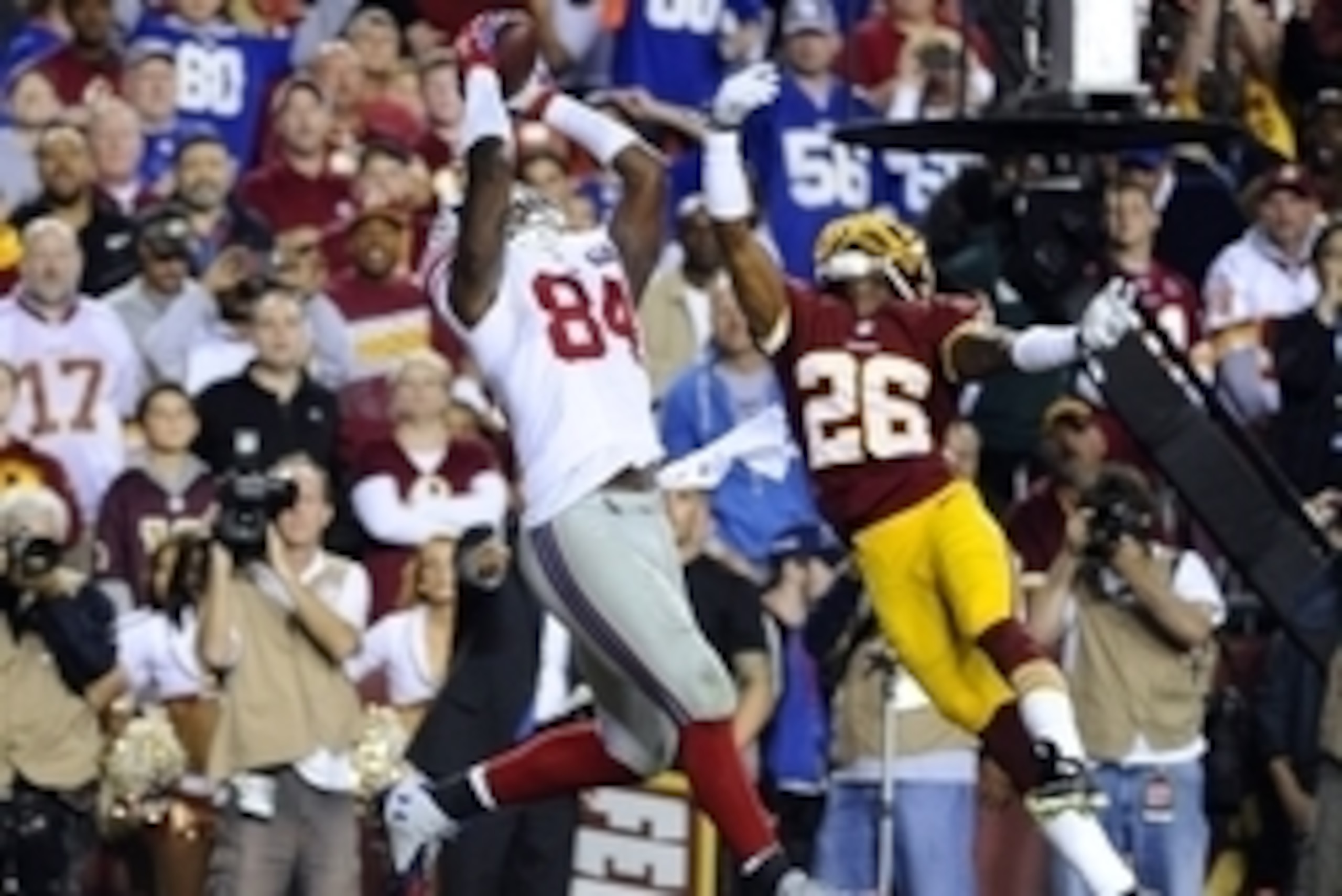 Sep 25, 2014; Landover, MD, USA; New York Giants tight end Larry Donnell (84) catches a touchdown pass as Washington Redskins strong safety Bashaud Breeland (26) defends during the first half at FedEx Field. Mandatory Credit: Brad Mills-USA TODAY Sports