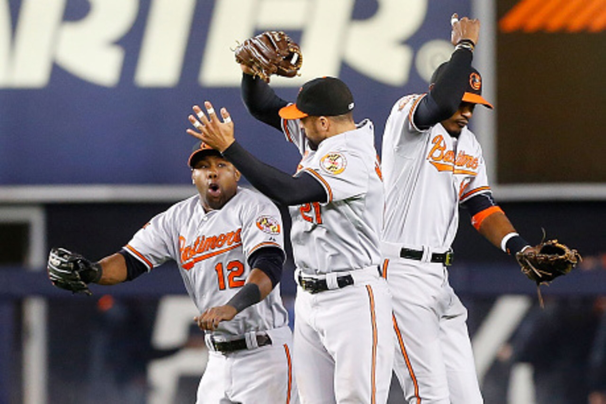 NEW YORK, NY - SEPTEMBER 23: Alejandro De Aza #12, Nick Markakis #21 and Adam Jones #10 of the Baltimore Orioles celebrate after defeating the New York Yankees at Yankee Stadium on September 23, 2014 in the Bronx borough of New York City. (Photo by Jim NEW YORK, NY - SEPTEMBER 23: Alejandro De Aza #12, Nick Markakis #21 and Adam Jones #10 of the Baltimore Orioles celebrate after defeating the New York Yankees at Yankee Stadium on September 23, 2014 in the Bronx borough of New York City. (Photo by Jim