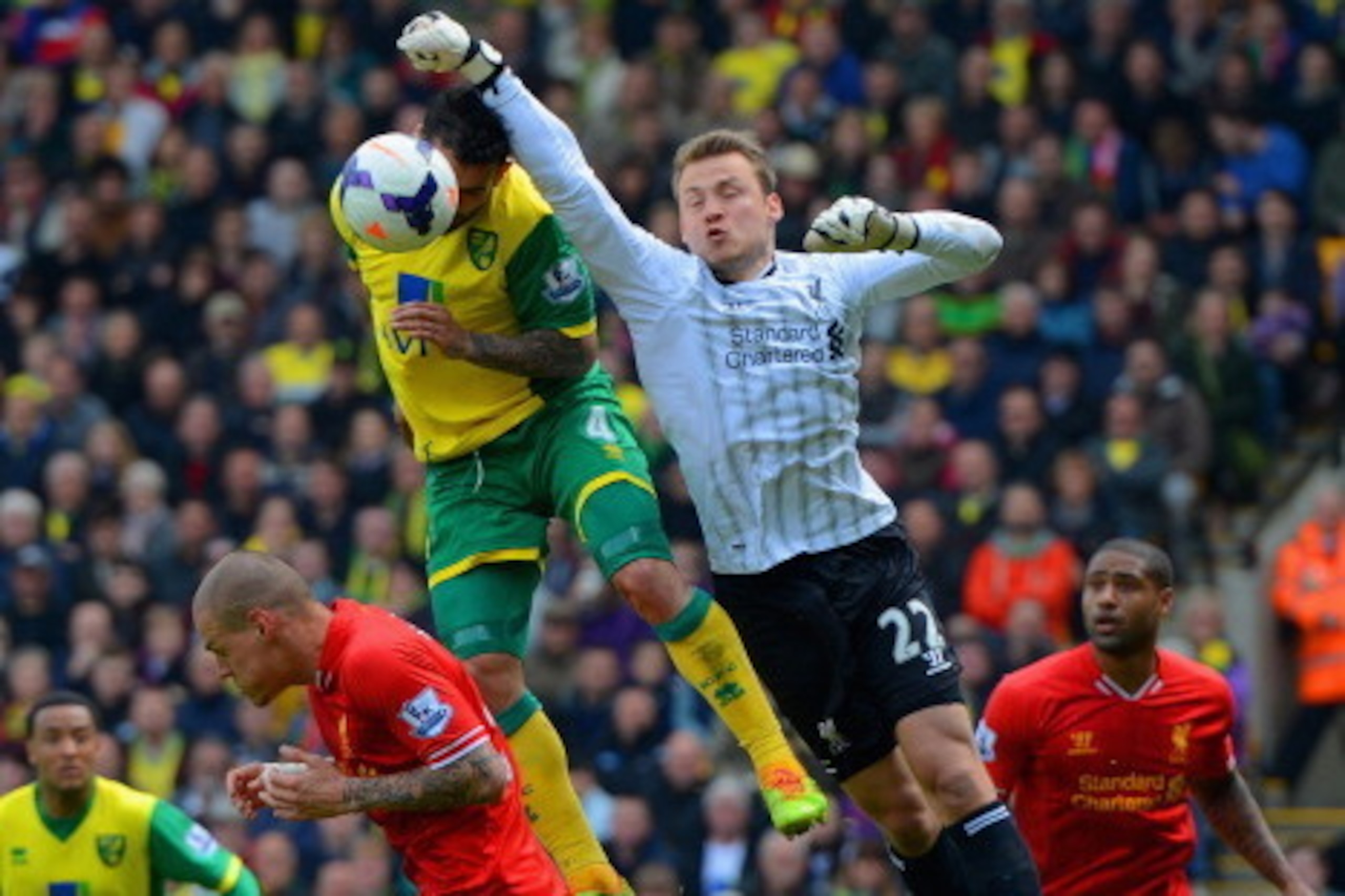NORWICH, ENGLAND - APRIL 20:  Simon Mignolet of Liverpool fails to punch the ball clear during the Barclays Premier League match between Norwich City and Liverpool at Carrow Road on April 20, 2014 in Norwich, England.  (Photo by Michael Regan/Getty Images