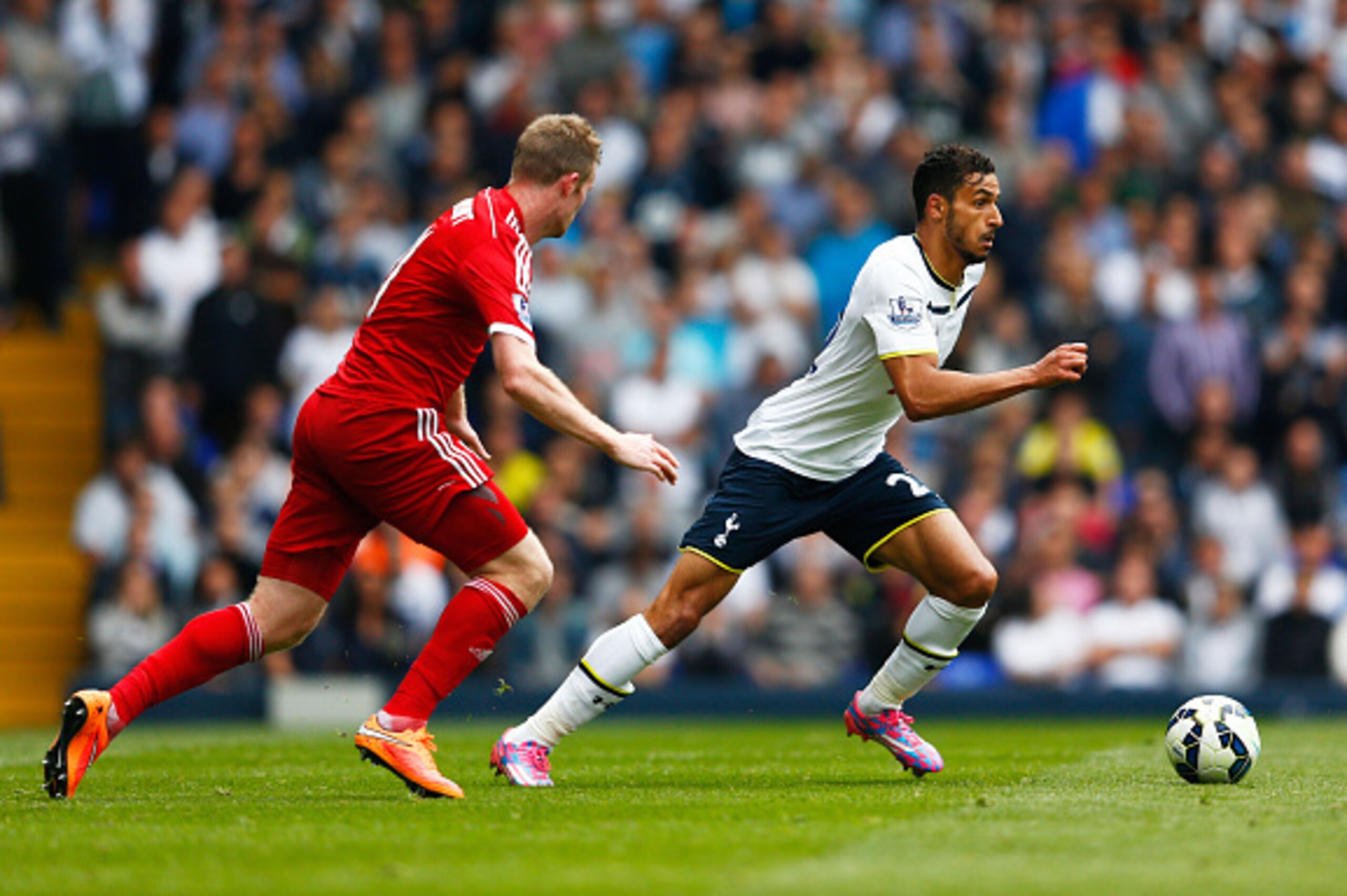 LONDON, ENGLAND - SEPTEMBER 21:  Nacer Chadli of Spurs is pursued by Chris Brunt of West Brom during the Barclays Premier League match between Tottenham Hotspur and West Bromwich Albion at White Hart Lane on September 21, 2014 in London, England.  (Photo 