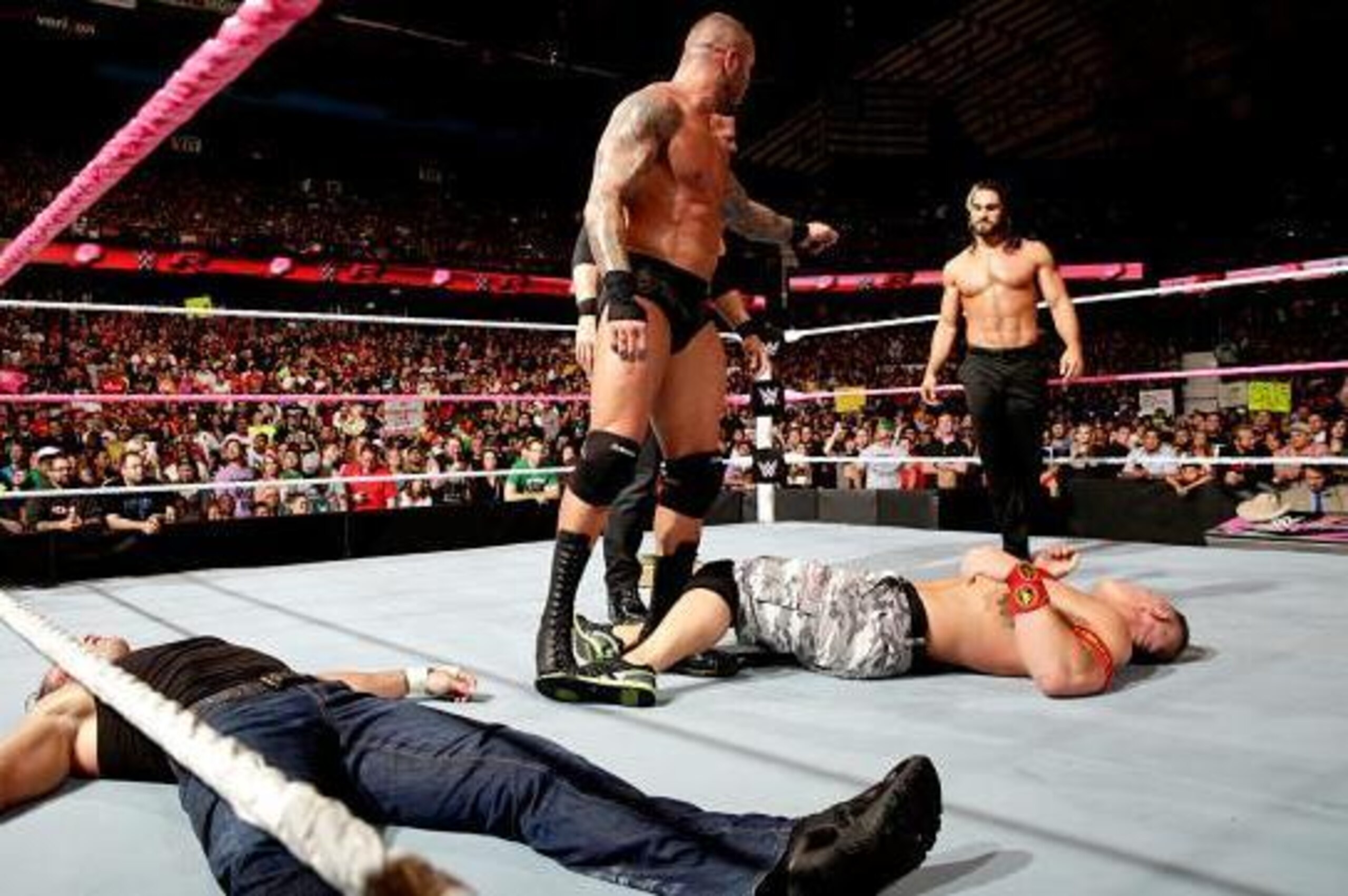 Randy Orton, Kane and Seth Rollins stand over a fallen Dean Ambrose and John Cena.
