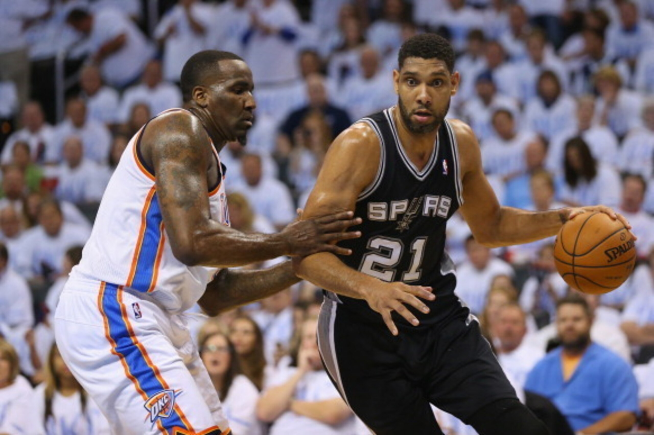 OKLAHOMA CITY, OK - MAY 31:  Tim Duncan #21 of the San Antono Spurs drives with the ball against Kendrick Perkins #5 of the Oklahoma City Thunder in the first half during Game Six of the Western Conference Finals of the 2014 NBA Playoffs at Chesapeake Ene