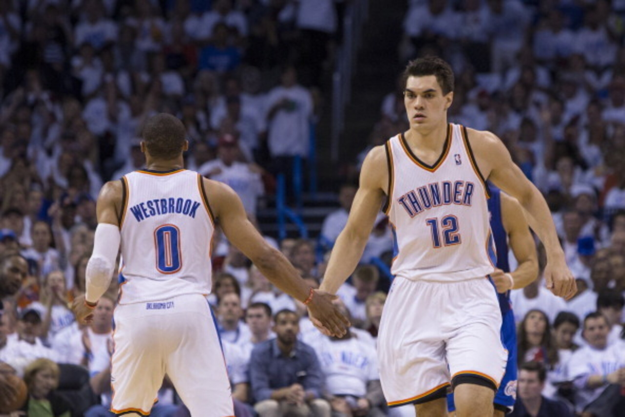 OKLAHOMA CITY, OK - May 13: Steven Adams #12 and Russell Westbrook #0 of the Oklahoma City Thunder celebrate in Game 5 of the Western Conference Semifinals against the Los Angeles Clippers during the 2014 NBA Playoffs at the Chesapeake Arena on May 13, 20