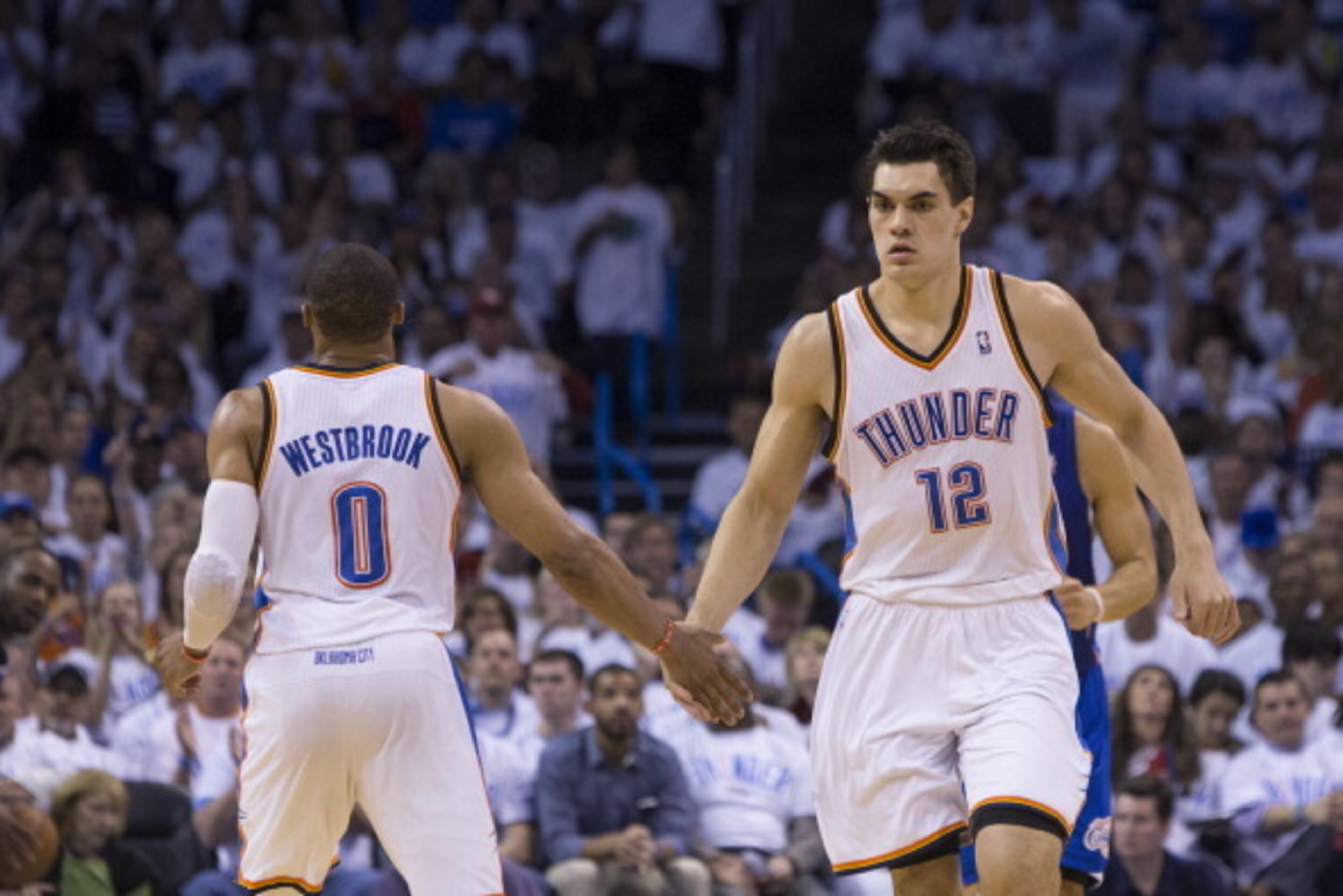 OKLAHOMA CITY, OK - May 13: Steven Adams #12 and Russell Westbrook #0 of the Oklahoma City Thunder celebrate in Game 5 of the Western Conference Semifinals against the Los Angeles Clippers during the 2014 NBA Playoffs at the Chesapeake Arena on May 13, 20