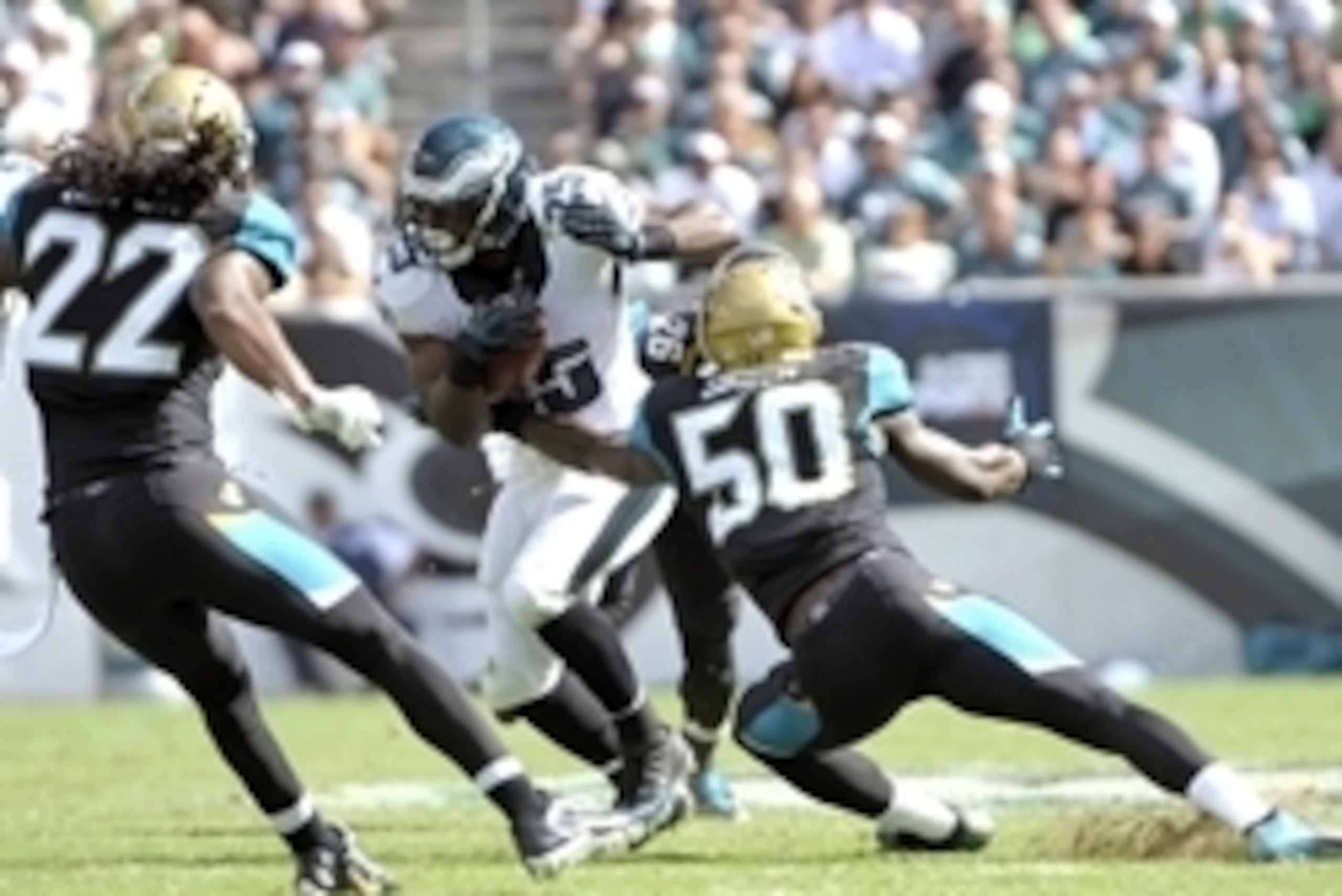 Sep 7, 2014; Philadelphia, PA, USA; Philadelphia Eagles running back LeSean McCoy (25) tries to move past Jacksonville Jaguars outside linebacker Telvin Smith (50) during the third quarter at Lincoln Financial Field. The Eagles defeated the Jaguars, 34-17
