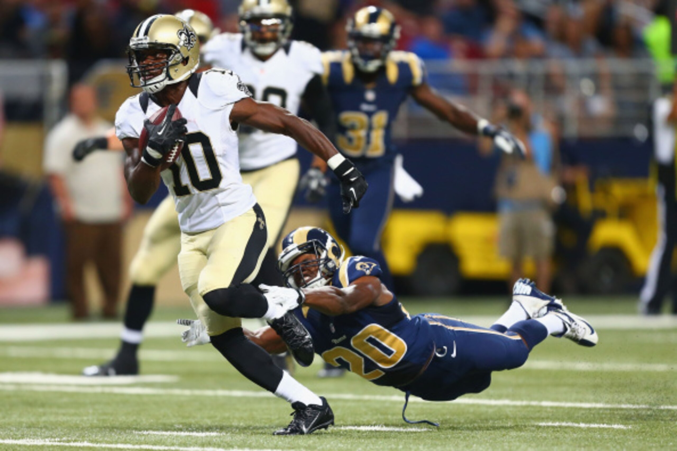 ST. LOUIS, MO - AUGUST 8: Brandin Cooks #10 of the New Orleans Saints runs upfield on his way to scoring a touchdown after making a catch against Lamarcus Joyner #20 of the St. Louis Rams during the second half of a pre-season game at the Edward Jones Dom