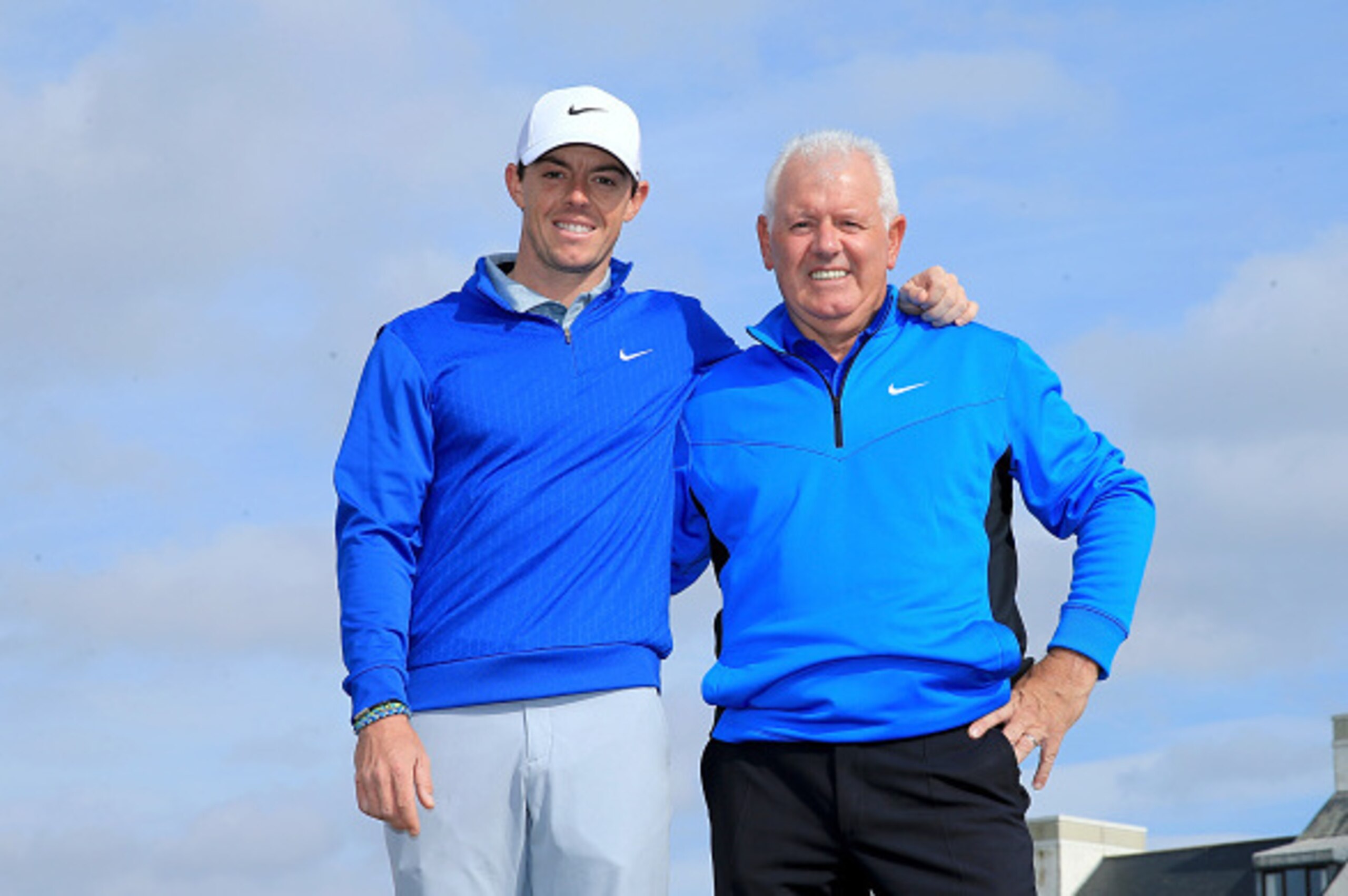 CARNOUSTIE, SCOTLAND - SEPTEMBER 30: Rory McIlroy of Northern Ireland poses whilst enjoying a few holes at Carnoustie with his father Gerry McIlroy during the practice round prior to the 2014 Alfred Dunhill Links Championship on the Championship Links on 