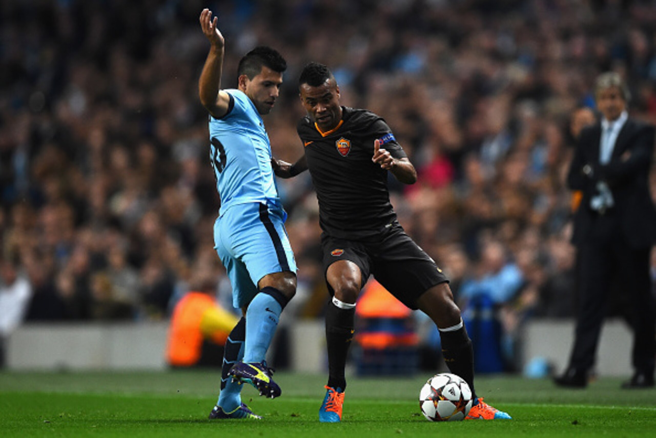 MANCHESTER, ENGLAND - SEPTEMBER 30:  Sergio Aguero of Manchester City competes with Ashley Cole of AS Roma during the UEFA Champions League Group E match between Manchester City FC and AS Roma  on September 30, 2014 in Manchester, United Kingdom.  (Photo 
