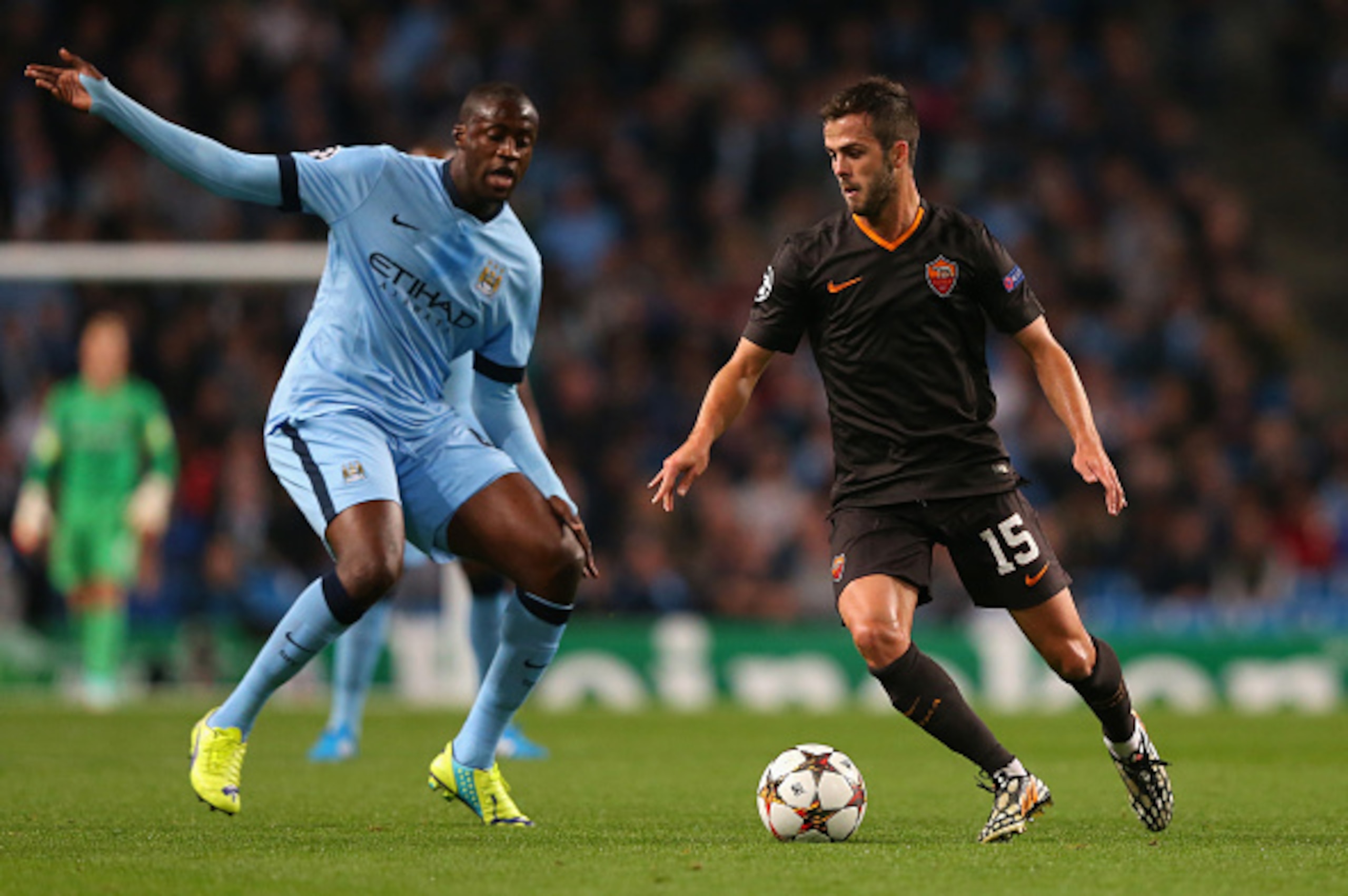 MANCHESTER, ENGLAND - SEPTEMBER 30:  Miralem Pjanic of AS Roma competes with Yaya Toure of Manchester City during the UEFA Champions League Group E match between Manchester City FC and AS Roma  on September 30, 2014 in Manchester, United Kingdom.  (Photo 