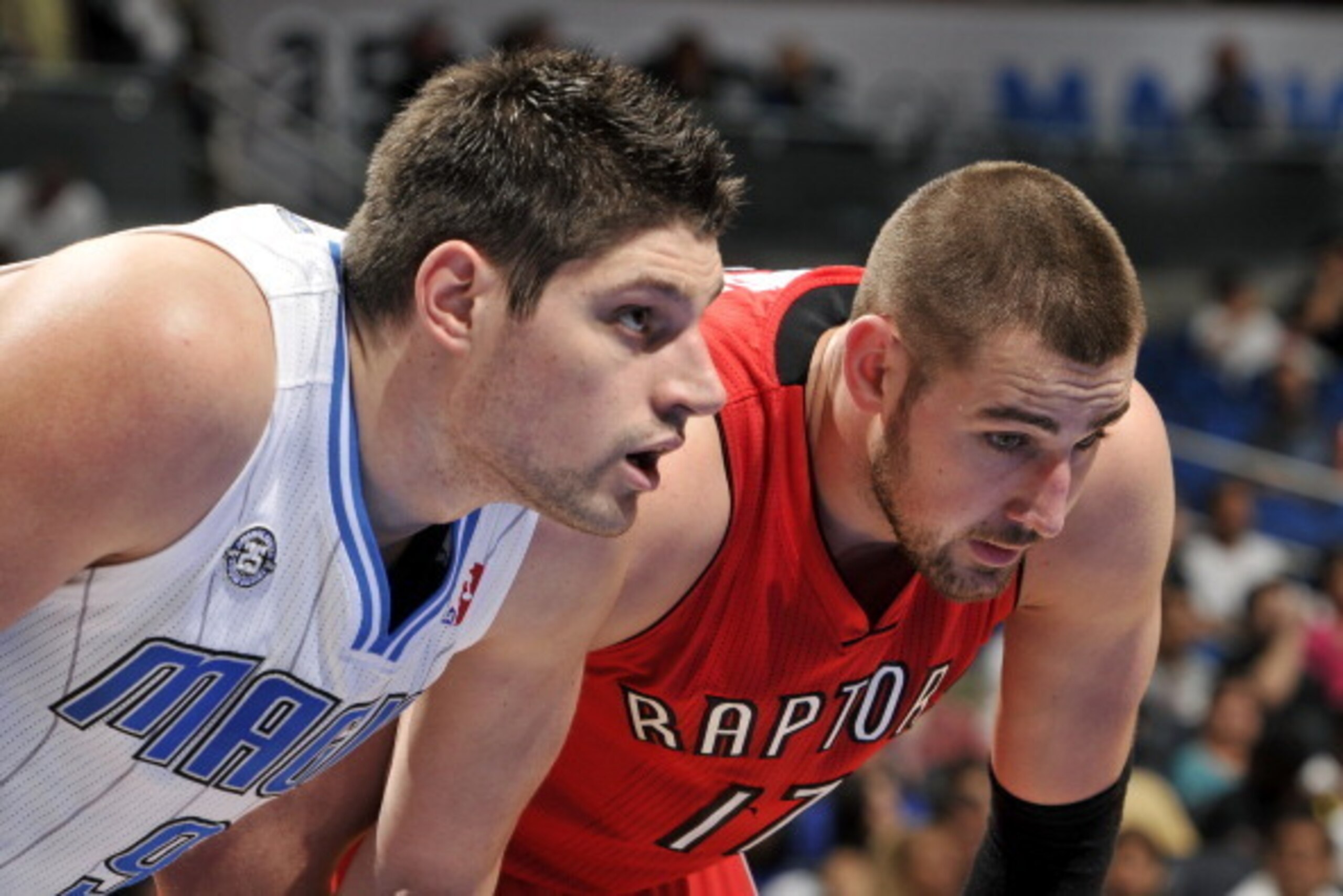 ORLANDO, FL - MARCH 30: Nikola Vucevic #9 of the Orlando Magic battles for position against Jonas Valanciunas #17 of the Toronto Raptors on March 30, 2014 at Amway Center in Orlando, Florida. NOTE TO USER: User expressly acknowledges and agrees that, by d