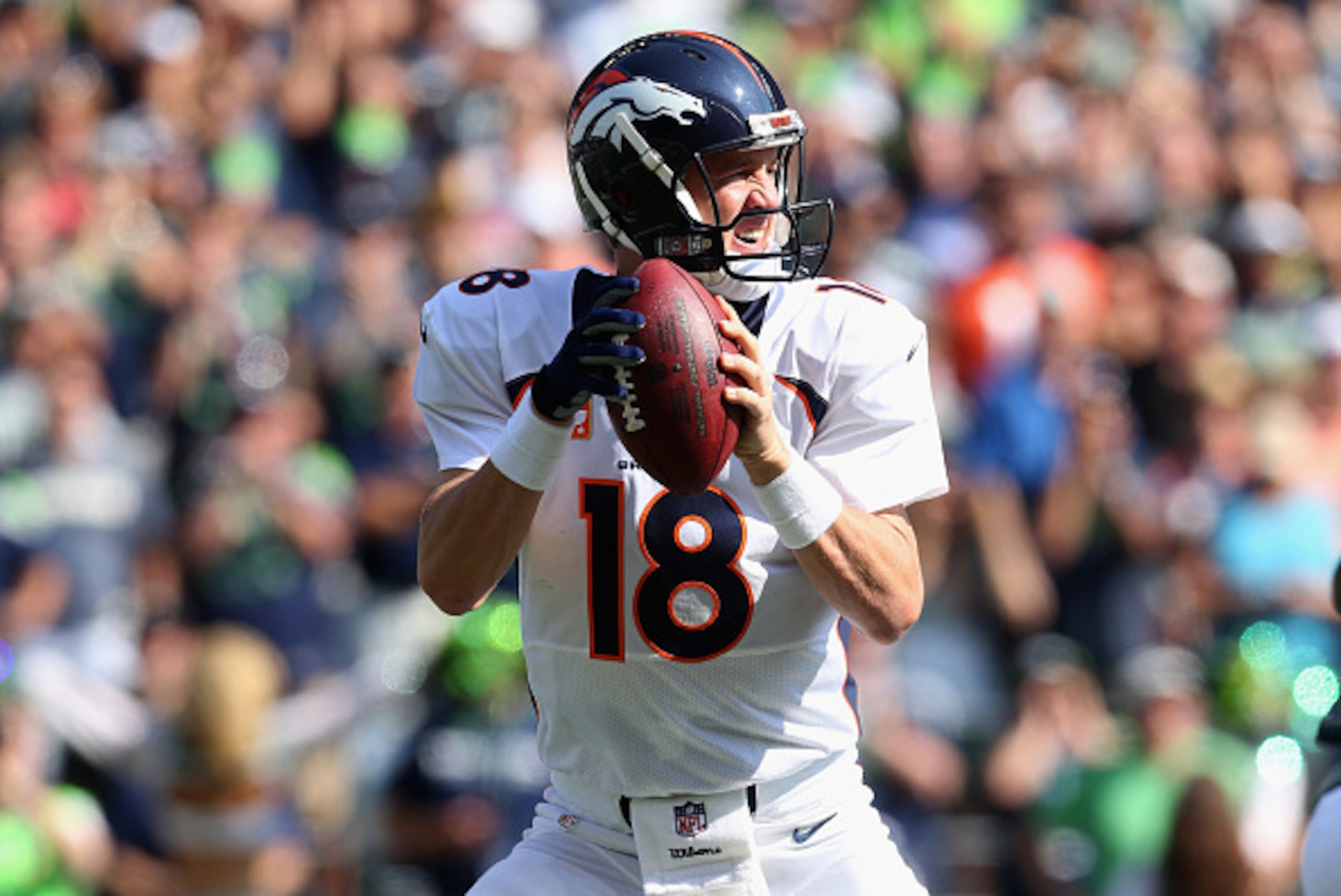 SEATTLE, WA - SEPTEMBER 21:  Quarterback Peyton Manning #18 of the Denver Broncos drops back to pass against the Seattle Seahawks at CenturyLink Field on September 21, 2014 in Seattle, Washington.  (Photo by Jeff Gross/Getty Images)