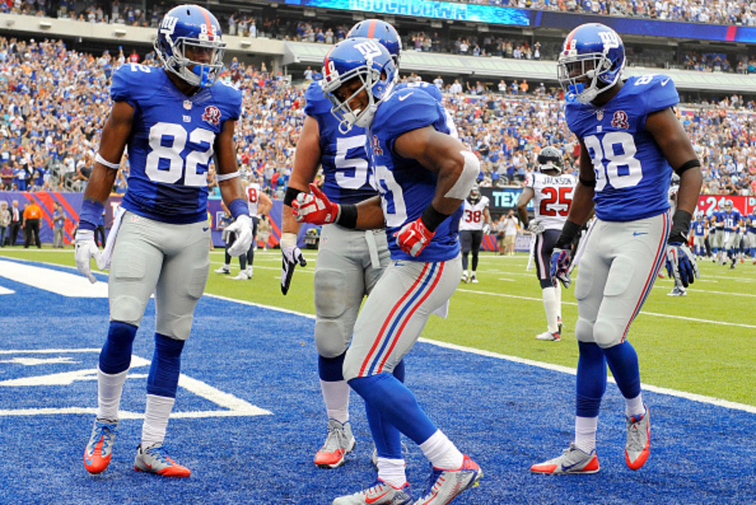 EAST RUTHERFORD, NJ - SEPTEMBER 21:   Victor Cruz #80 of the New York Giants celebrates his touchdown with a dance against the Houston Texans in the second quarter at MetLife Stadium on September 21, 2014 in East Rutherford, New Jersey.  (Photo by Alex Go