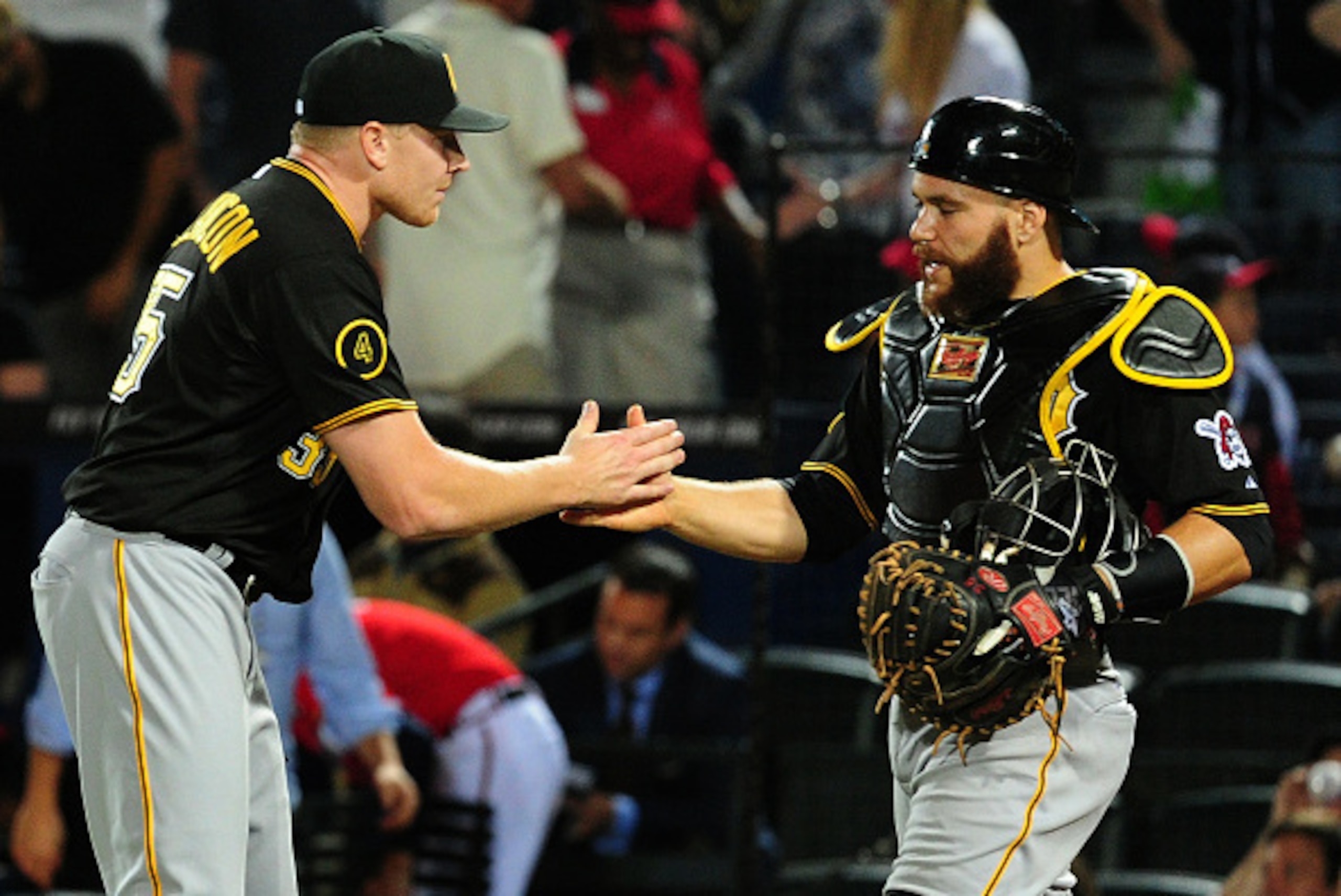 ATLANTA, GA - SEPTEMBER 22: Mark Melancon #35 and Russell Martin #55 of the Pittsburgh Pirates celebrate after the game against the Atlanta Braves at Turner Field on September 22, 2014 in Atlanta, Georgia. (Photo by Scott Cunningham/Getty Images)