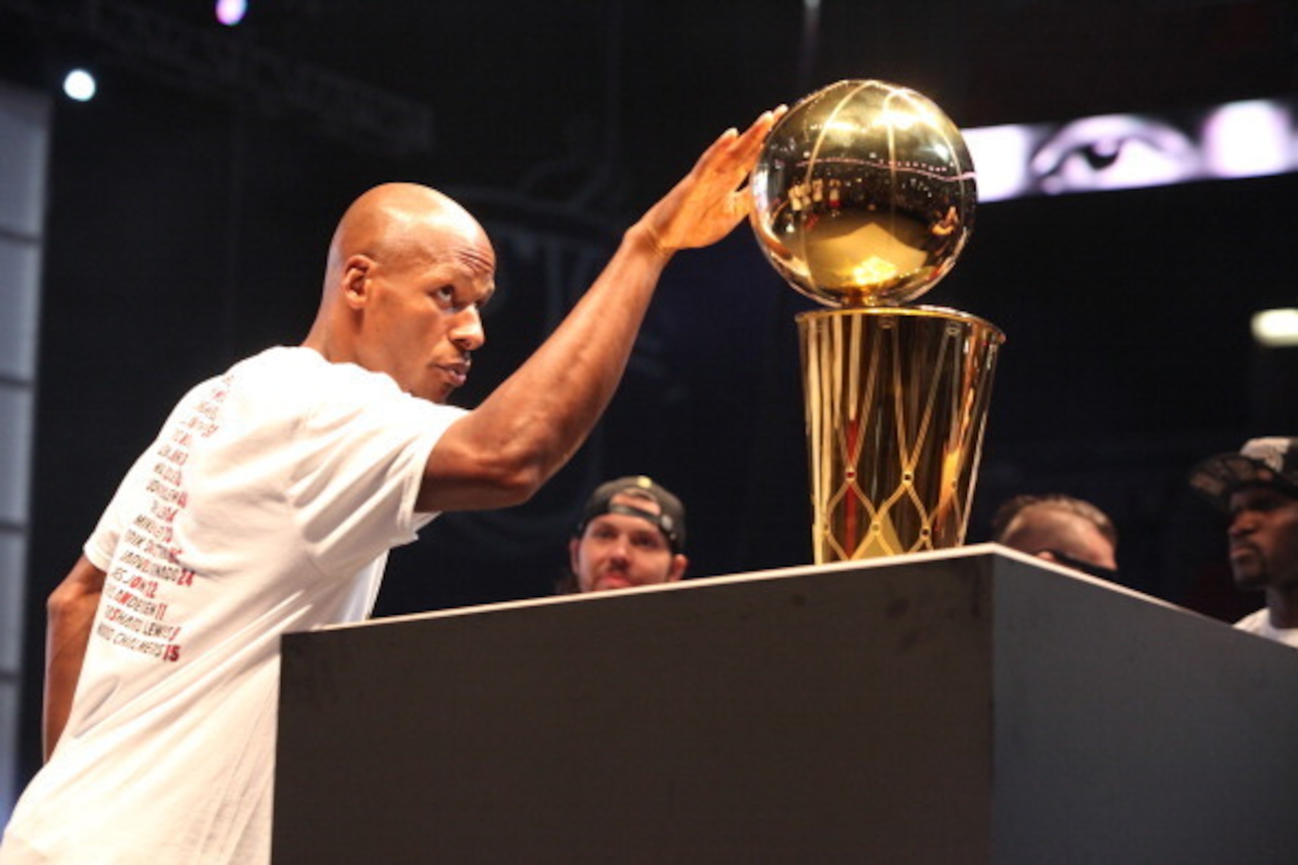 MIAMI, FL - JUNE 24: Ray Allen #34 of the Miami Heat touches the Larry O'Brien trophy during the NBA championship parade through downtown on June 24, 2013 in Miami, Florida. NOTE TO USER: User expressly acknowledges and agrees that, by downloading and or 