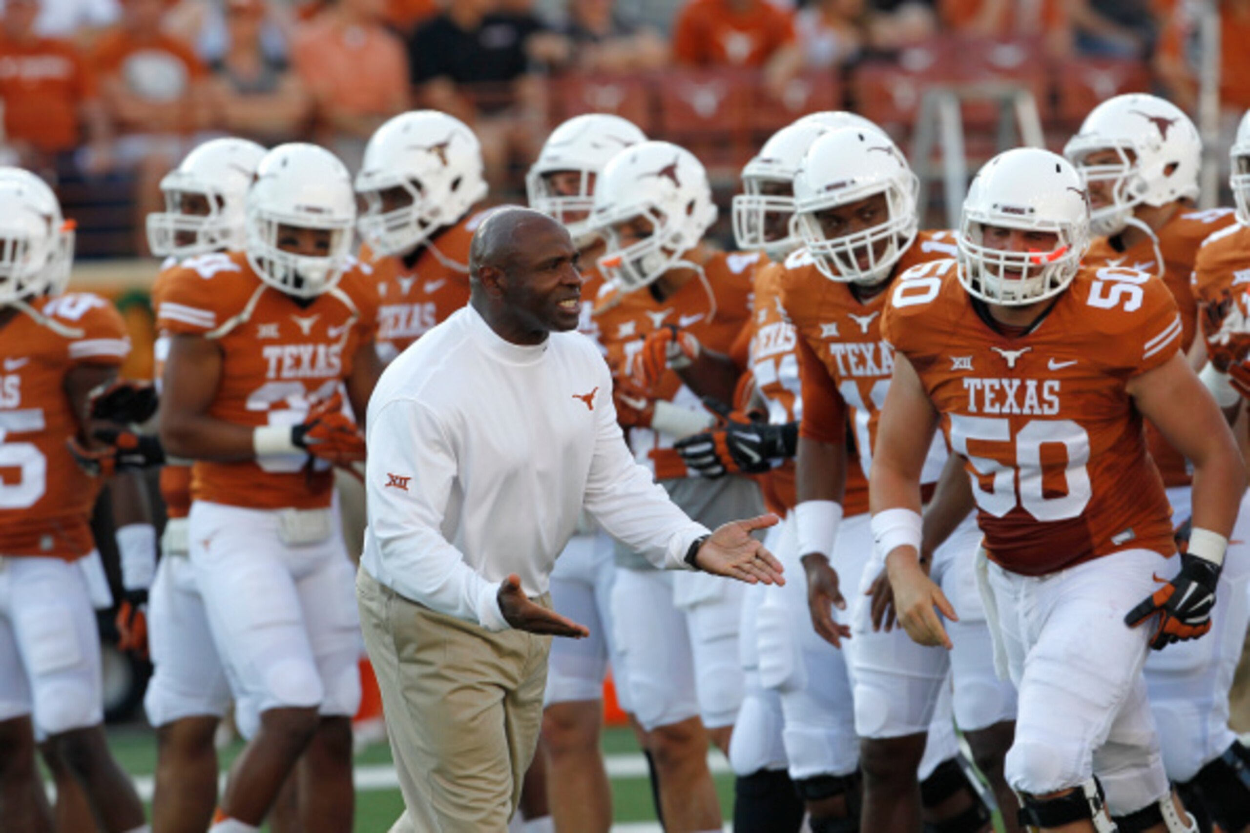 AUSTIN, TX - SEPTEMBER 6: Head coach Charlie Strong of the Texas Longhorns encourages his team in warmups before playing the BYU Cougars on September 6, 2014 at Darrell K Royal-Texas Memorial Stadium in Austin, Texas. (Photo by Chris Covatta/Getty Images)