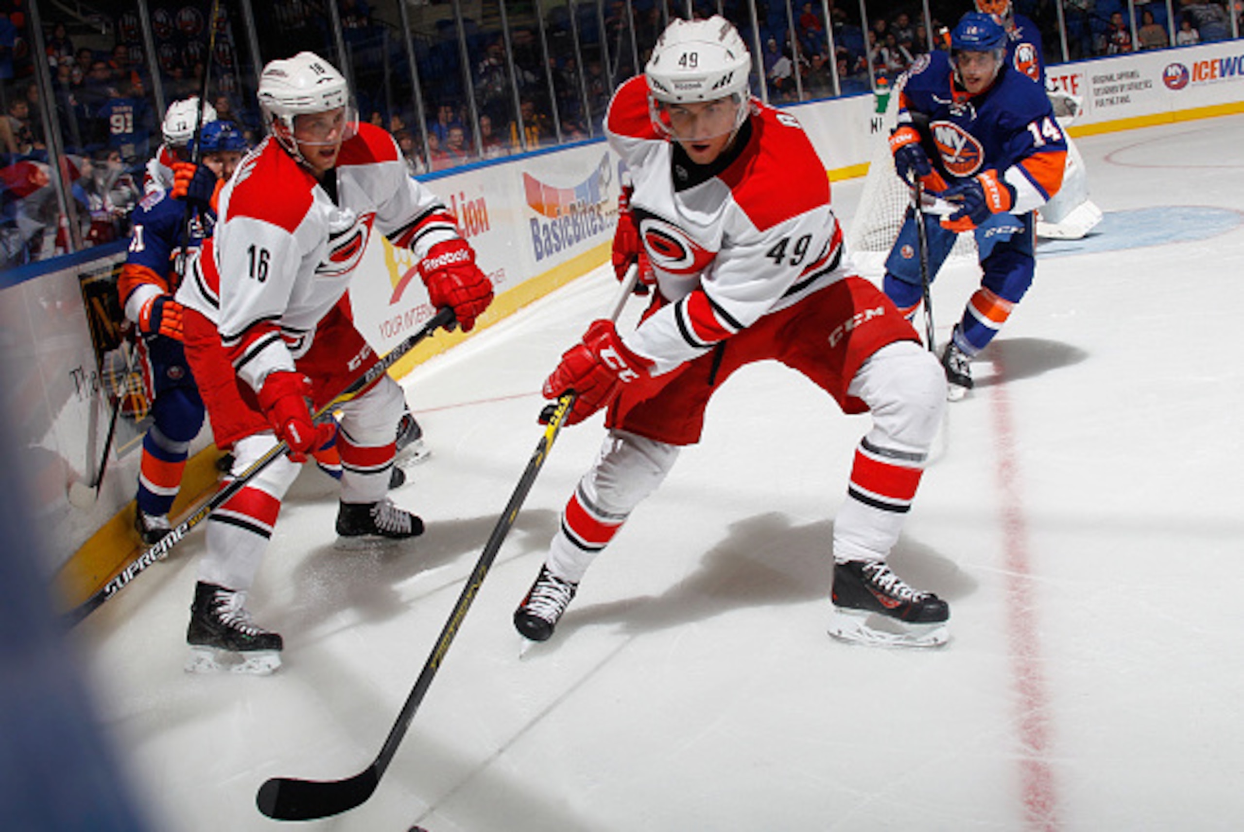 UNIONDALE, NY - SEPTEMBER 24: Victor Rask #49 of the Carolina Hurricanes moves the puck against the New York Islanders at the Nassau Veterans Memorial Coliseum on September 24, 2014 in Uniondale, New York.  (Photo by Bruce Bennett/Getty Images)