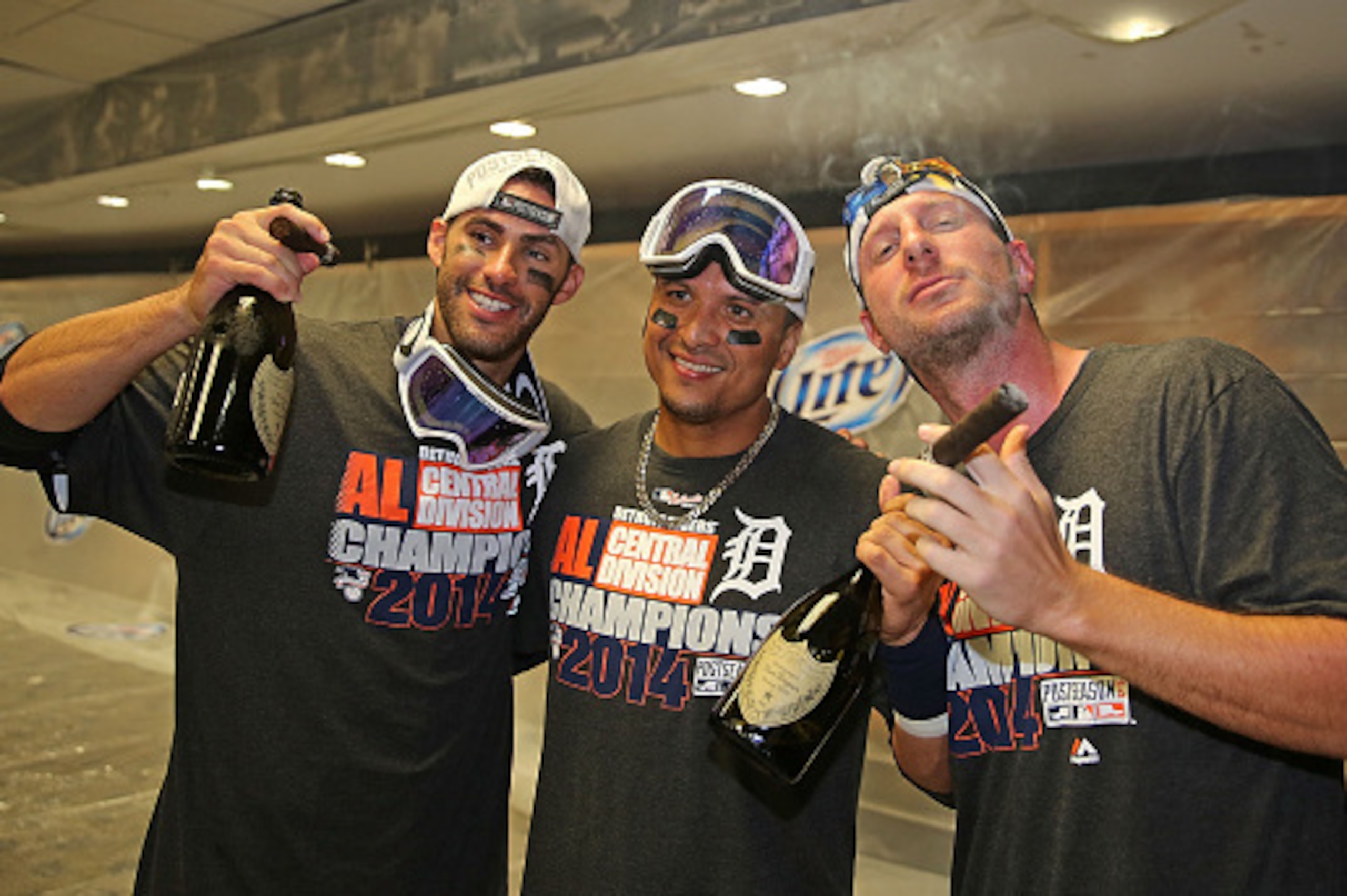 DETROIT, MI - SEPTEMBER 28:  J.D.Martinez #28 Victor Martinez #41 and Max Scherzer #37 of the Detroit Tigers celebrate a win over the Minnesota Twins and the Central Division Championship at Comerica Park on September 28, 2014 in Detroit, Michigan. The Ti