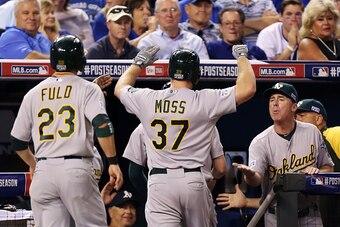 KANSAS CITY, MO - SEPTEMBER 30:  Brandon Moss #37 of the Oakland Athletics celebrates with teammates  after his three-run home run in the sixth inning against the Kansas City Royals during the American League Wild Card game at Kauffman Stadium on Septembe