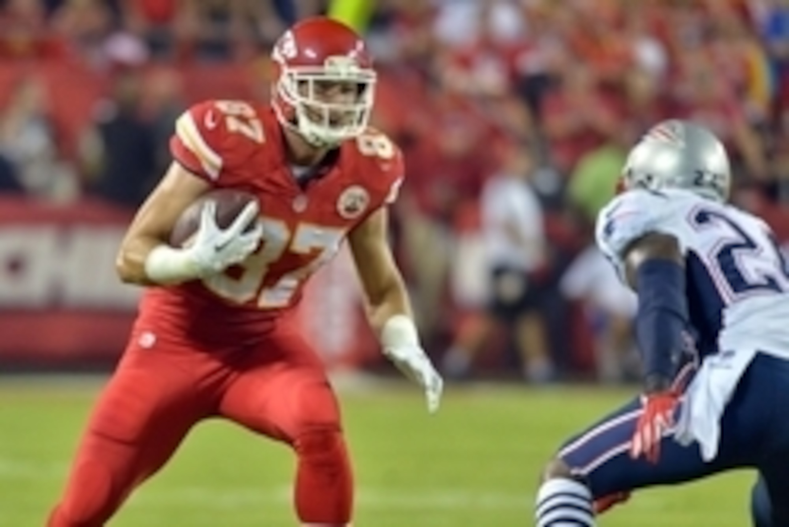 Sep 29, 2014; Kansas City, MO, USA; Kansas City Chiefs tight end Travis Kelce (87) catches a pass as New England Patriots cornerback Darrelle Revis (24) attempts the tackle during the first half at Arrowhead Stadium. Mandatory Credit: Denny Medley-USA TOD